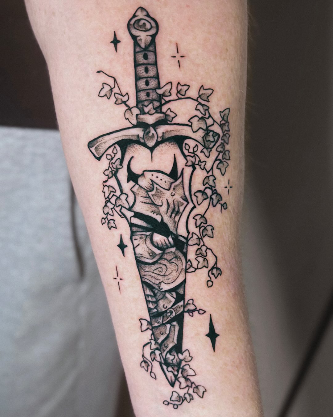 Sword and ivy black and grey tattoo on the forearm by Kal