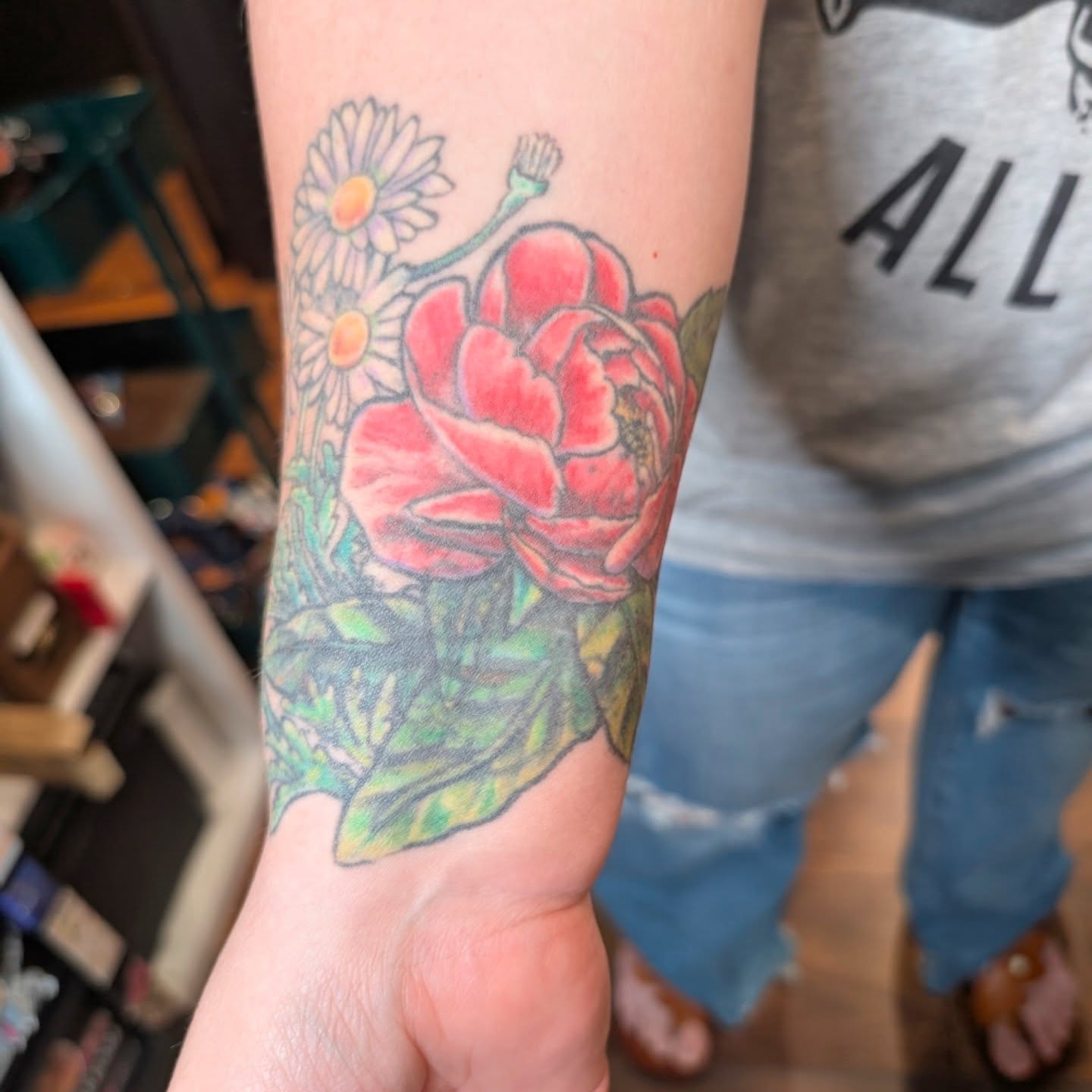 Peony and daisies new school tattoo on the forearm by Michaela May