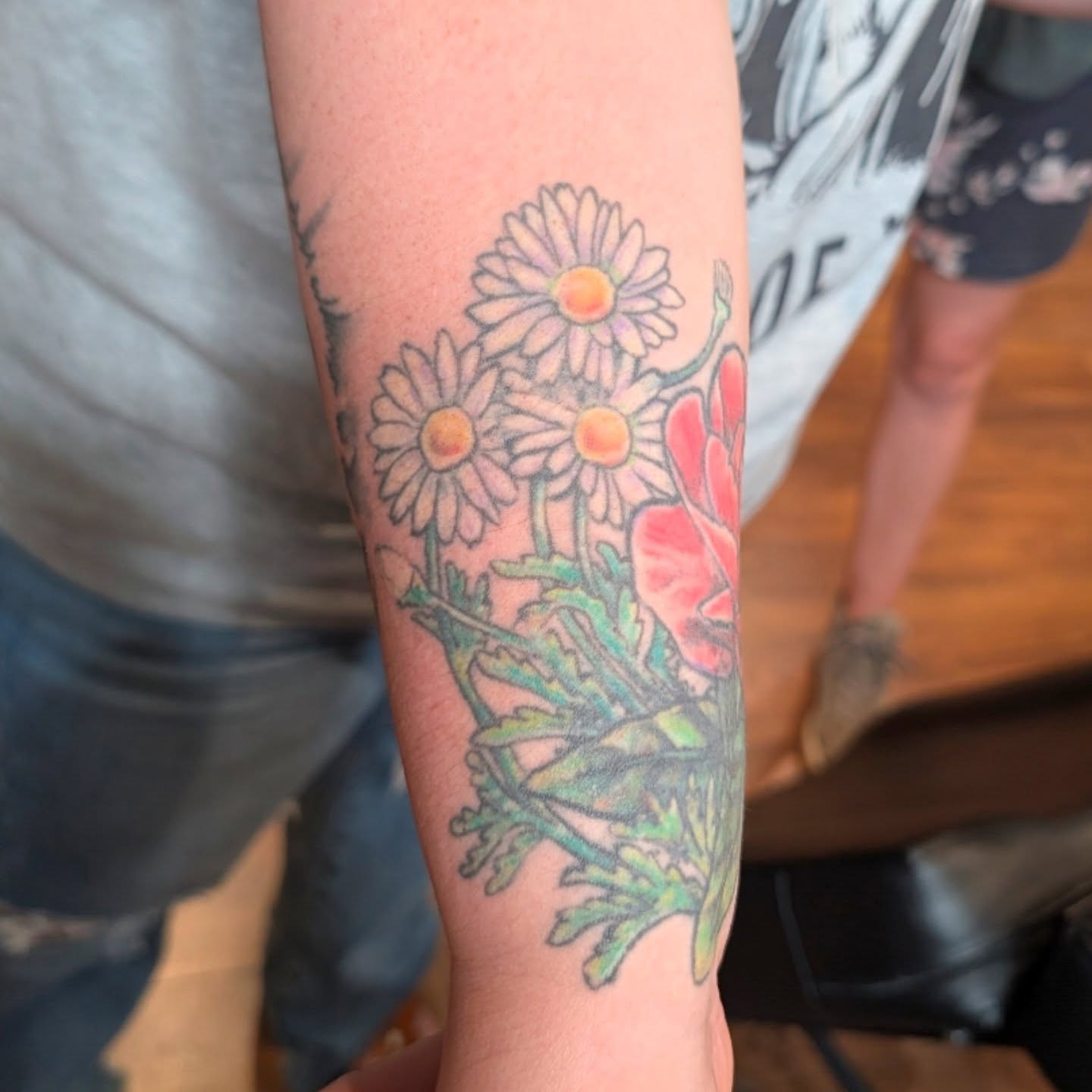 Daisies and poppies new school tattoo on the forearm by Michaela May