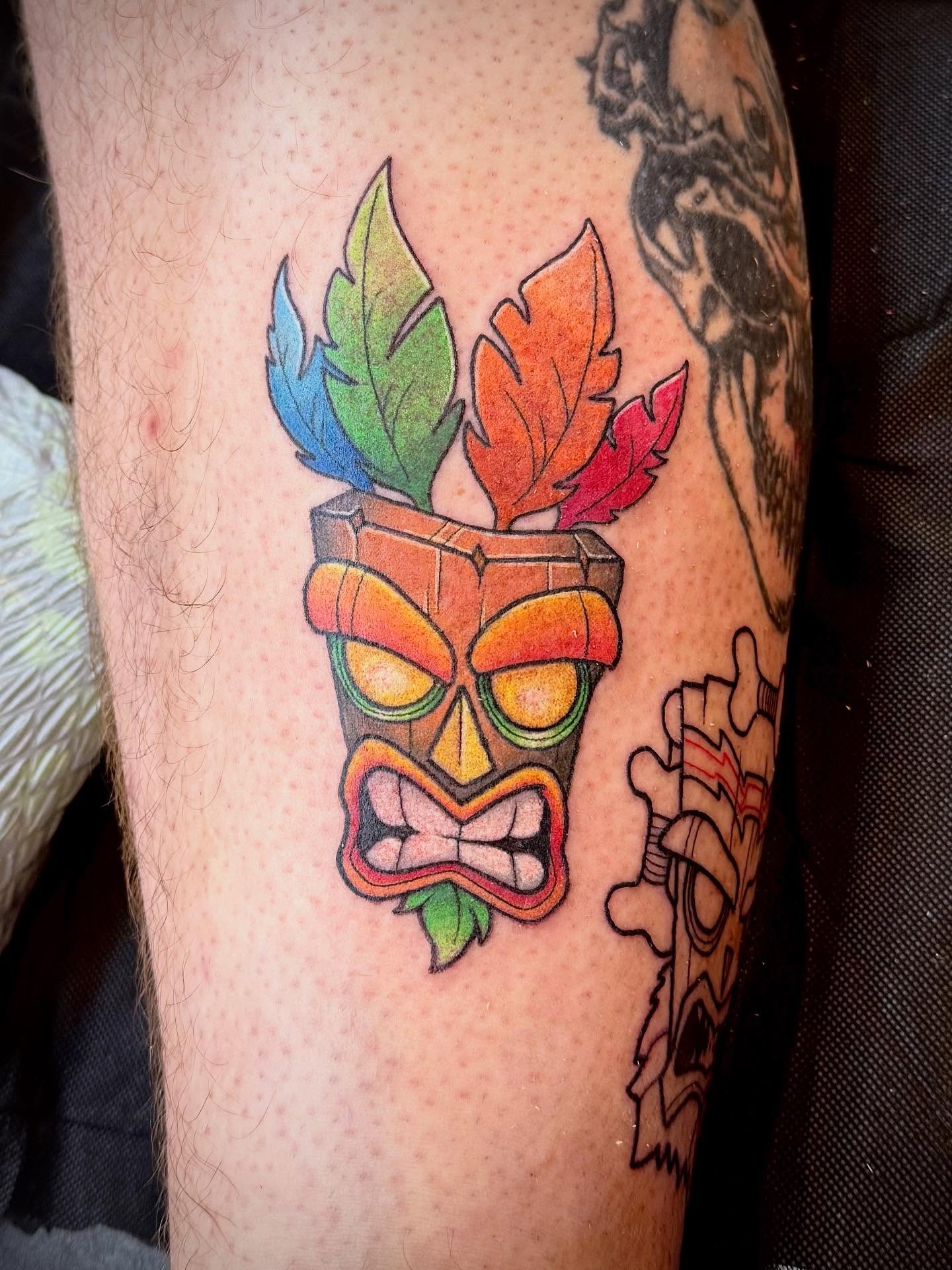 Tiki mask American traditional tattoo on the forearm by Ashley Kayser