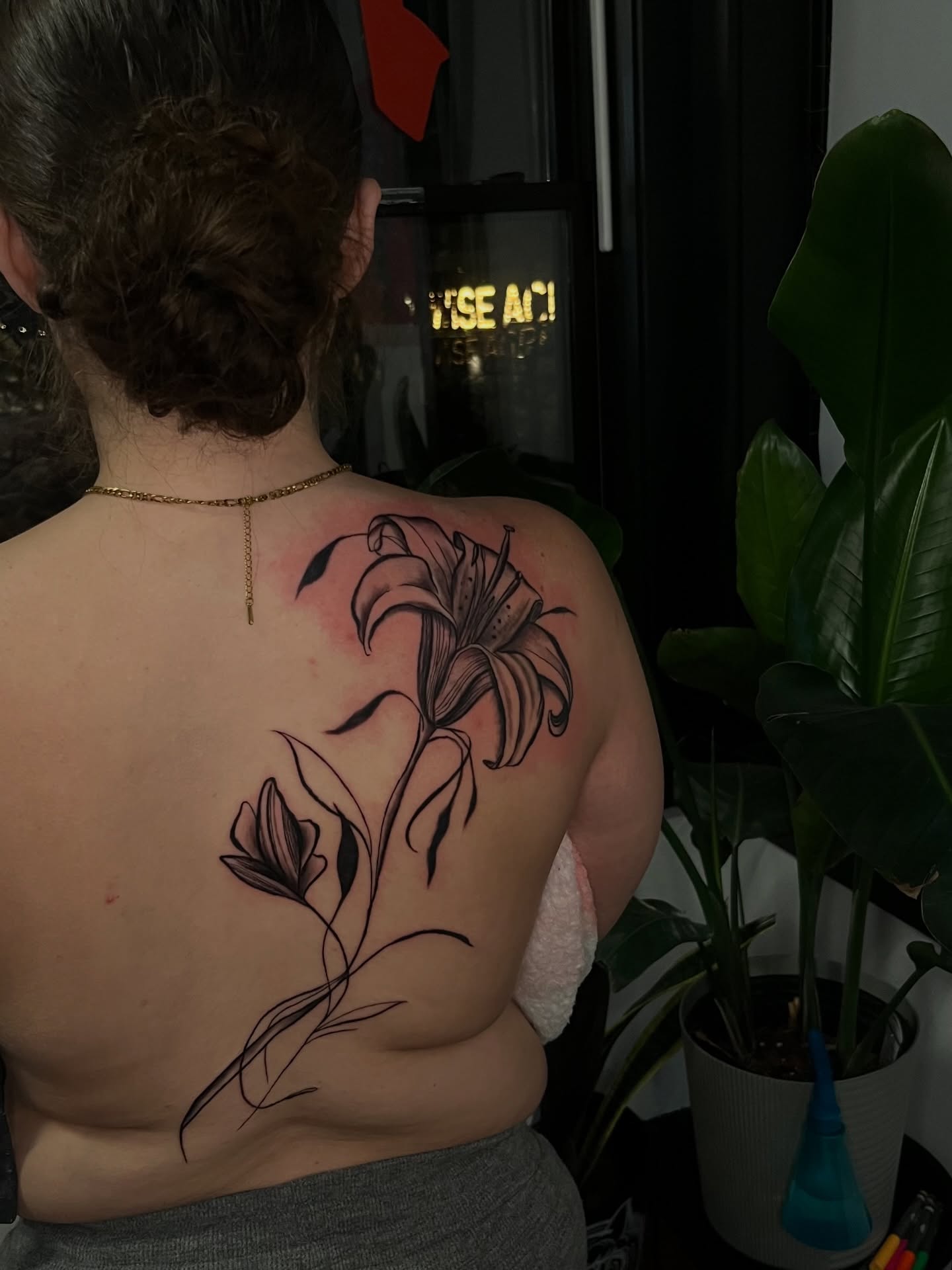 Lily black and grey tattoo on the back by Unknwn Ink ⭐️