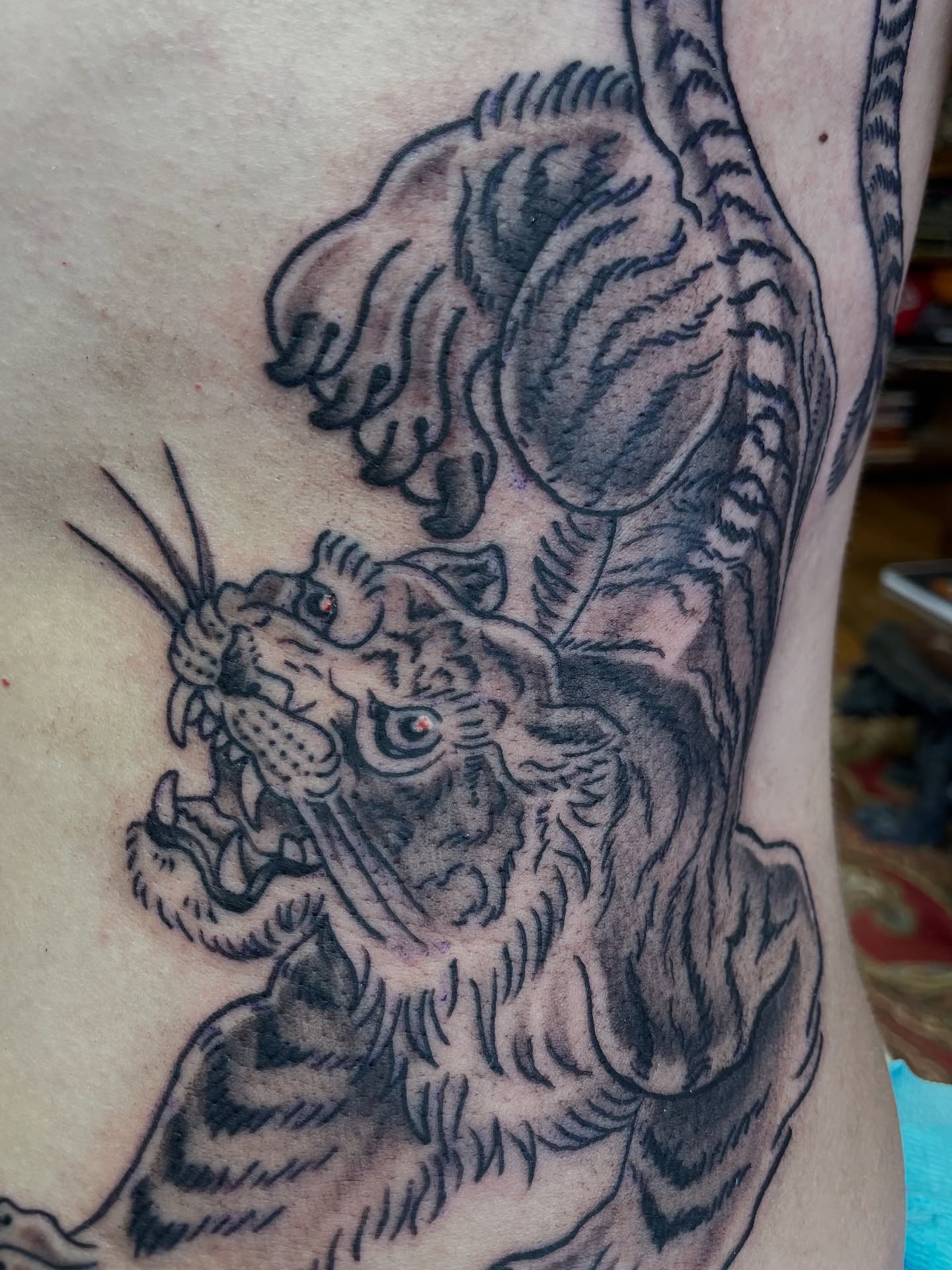 Tiger black and grey tattoo on the forearm by Strange Brew Tattoo