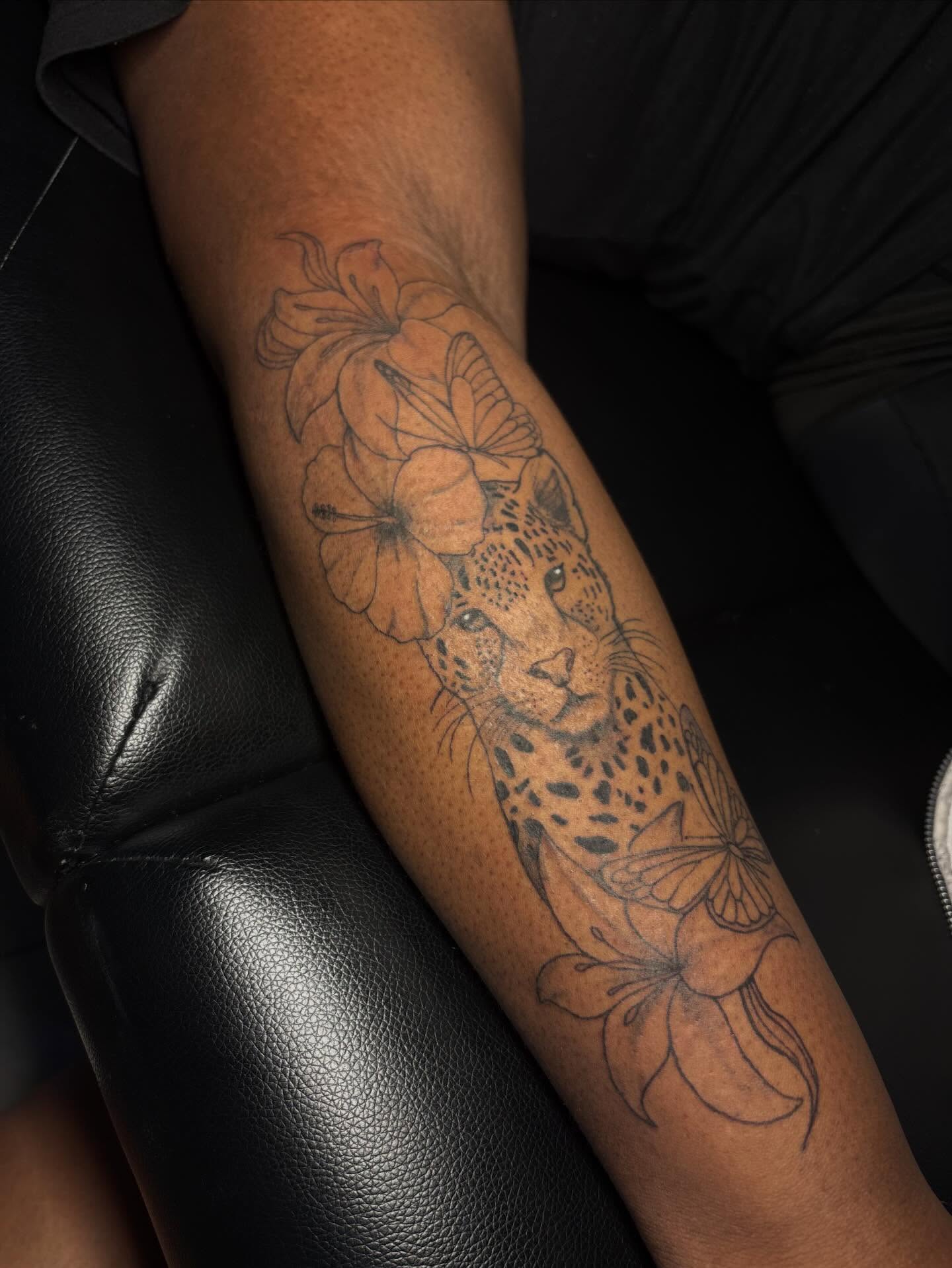 Cheetah and flowers realism tattoo on the forearm by addicted222inkk🎨