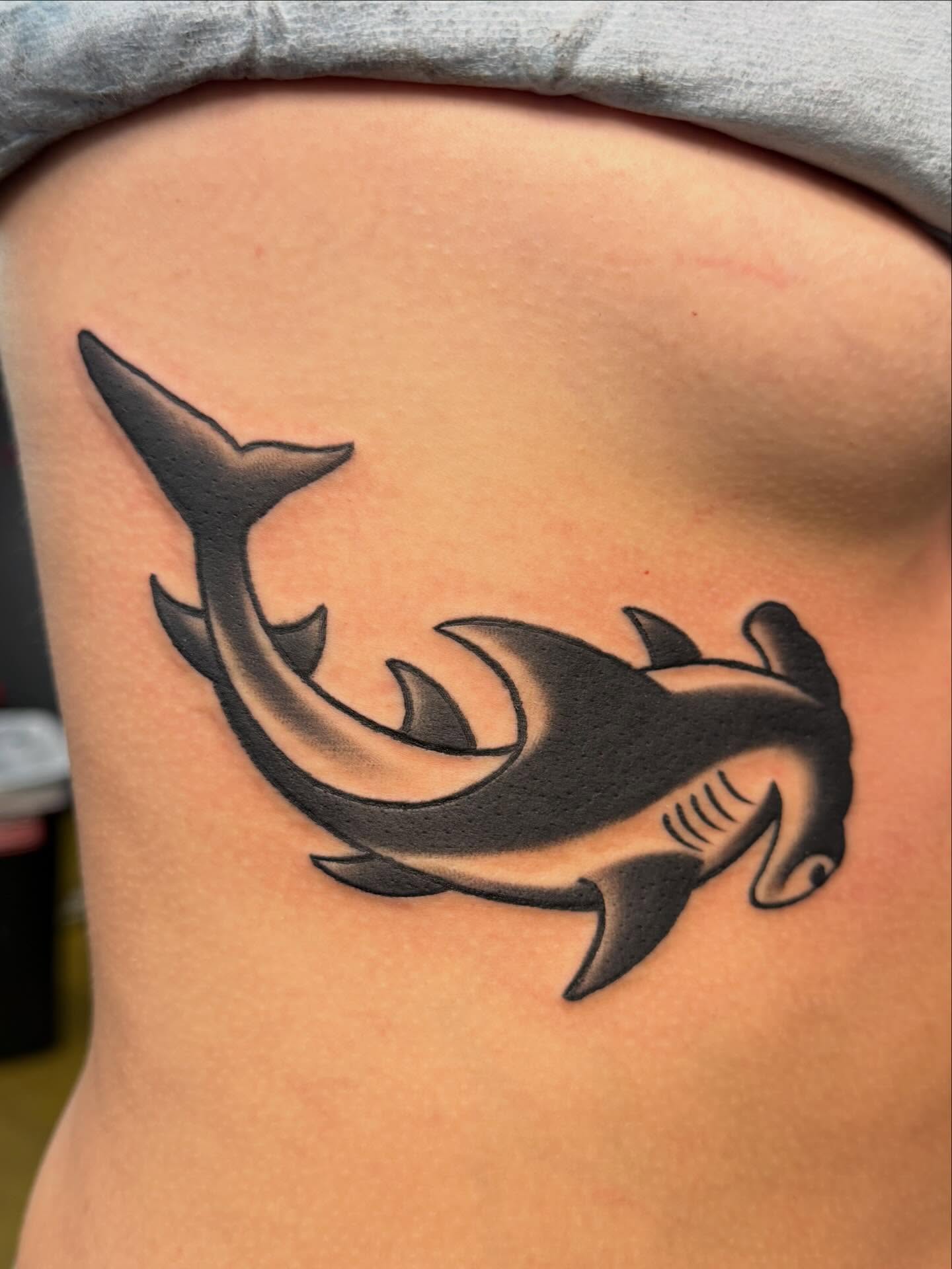 Hammerhead shark black and grey tattoo on the ribs by Shawn “Kluch” Hutto