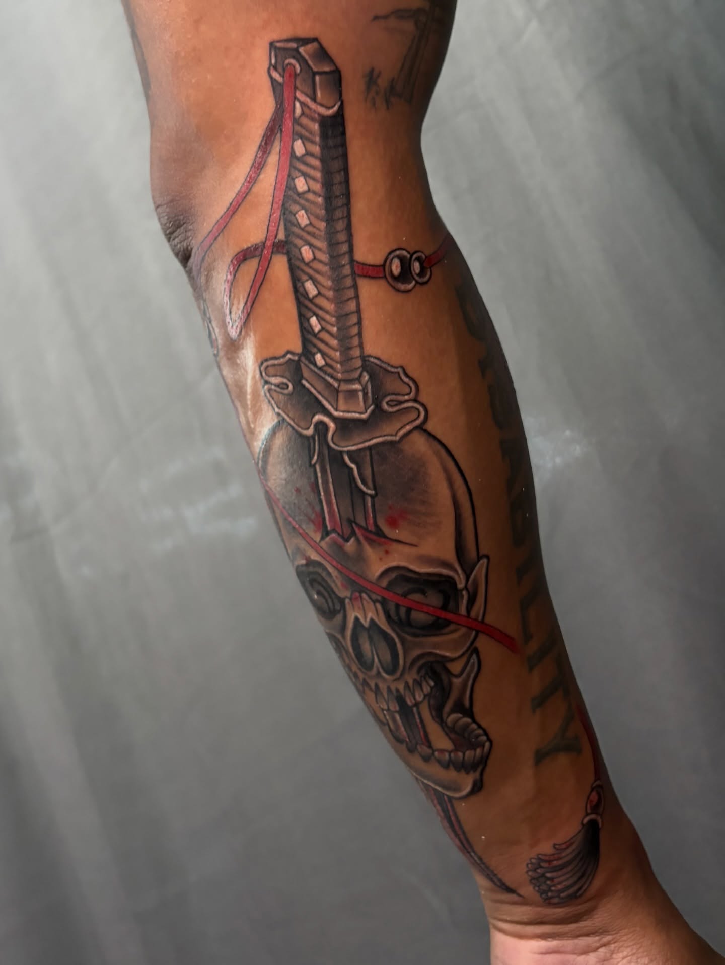 Knife and skull realism tattoo on the forearm by BodyArtByAlia