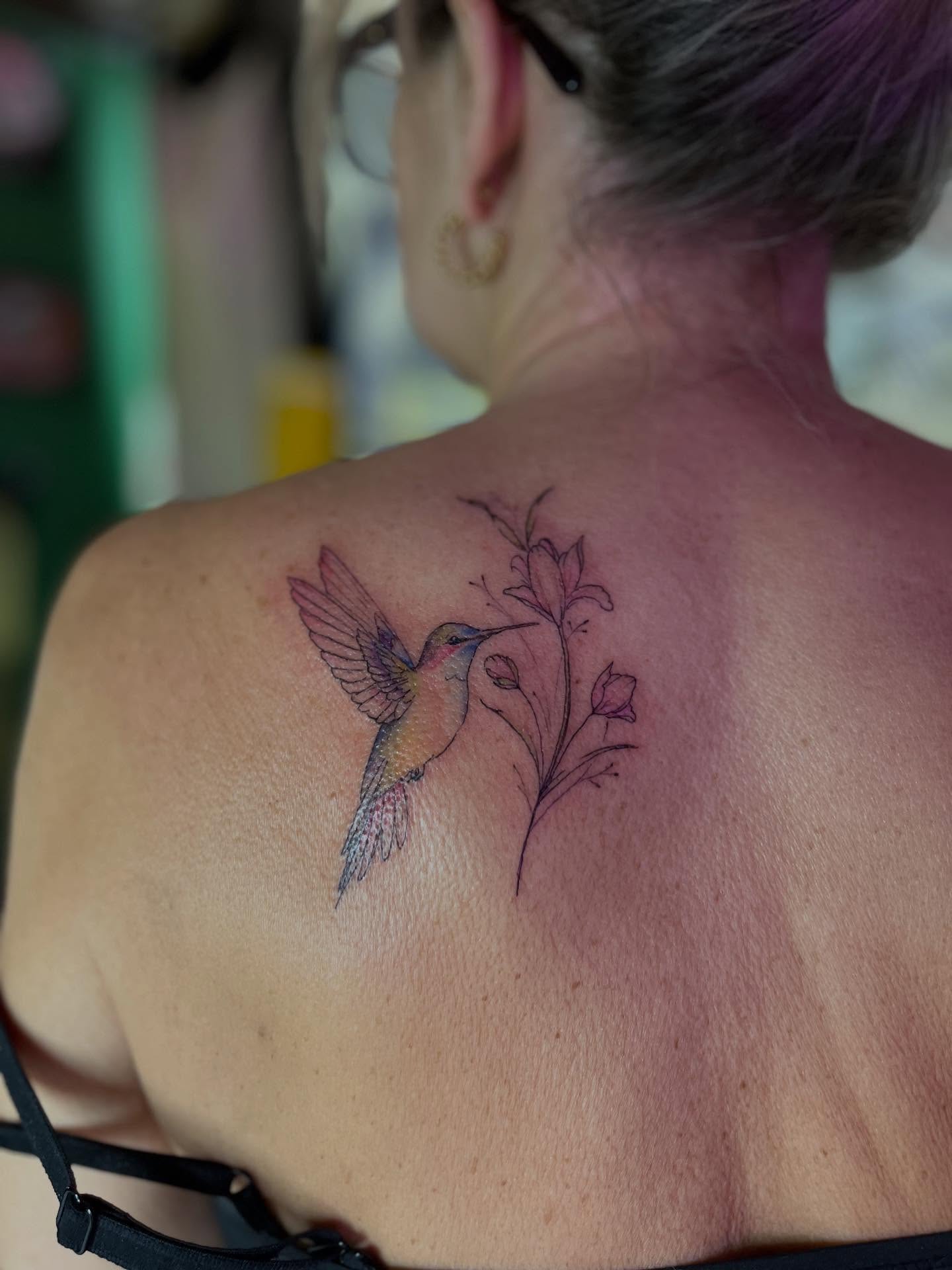 Hummingbird and flower watercolor tattoo on the back by Caitlin, Richmond, Virginia