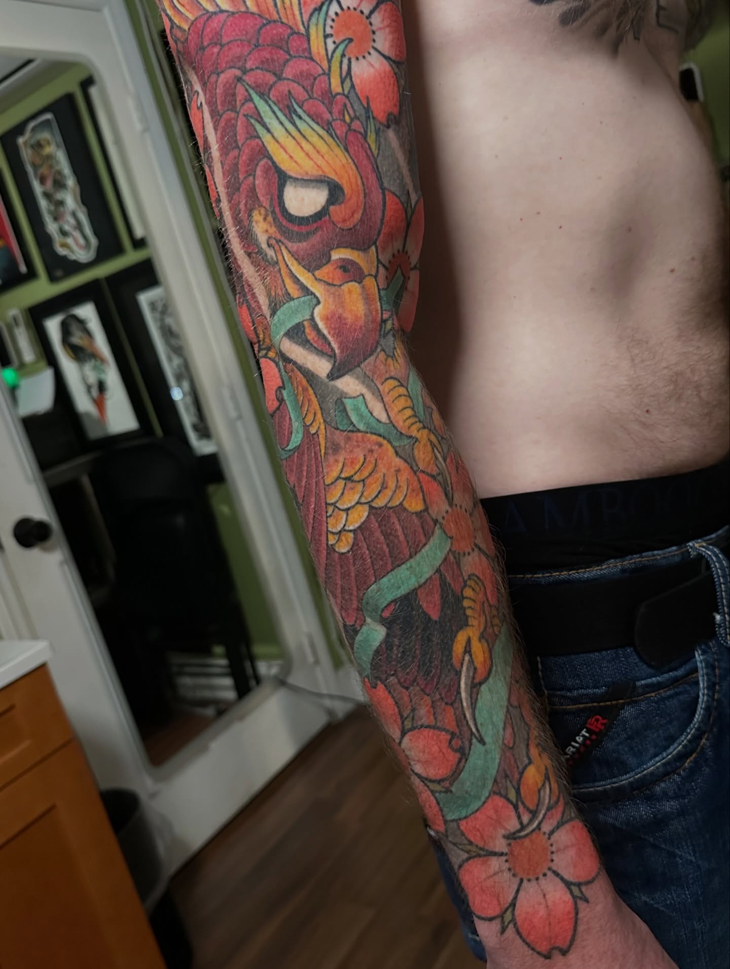 Bird and floral American traditional tattoo on the forearm by Trevor Burtz