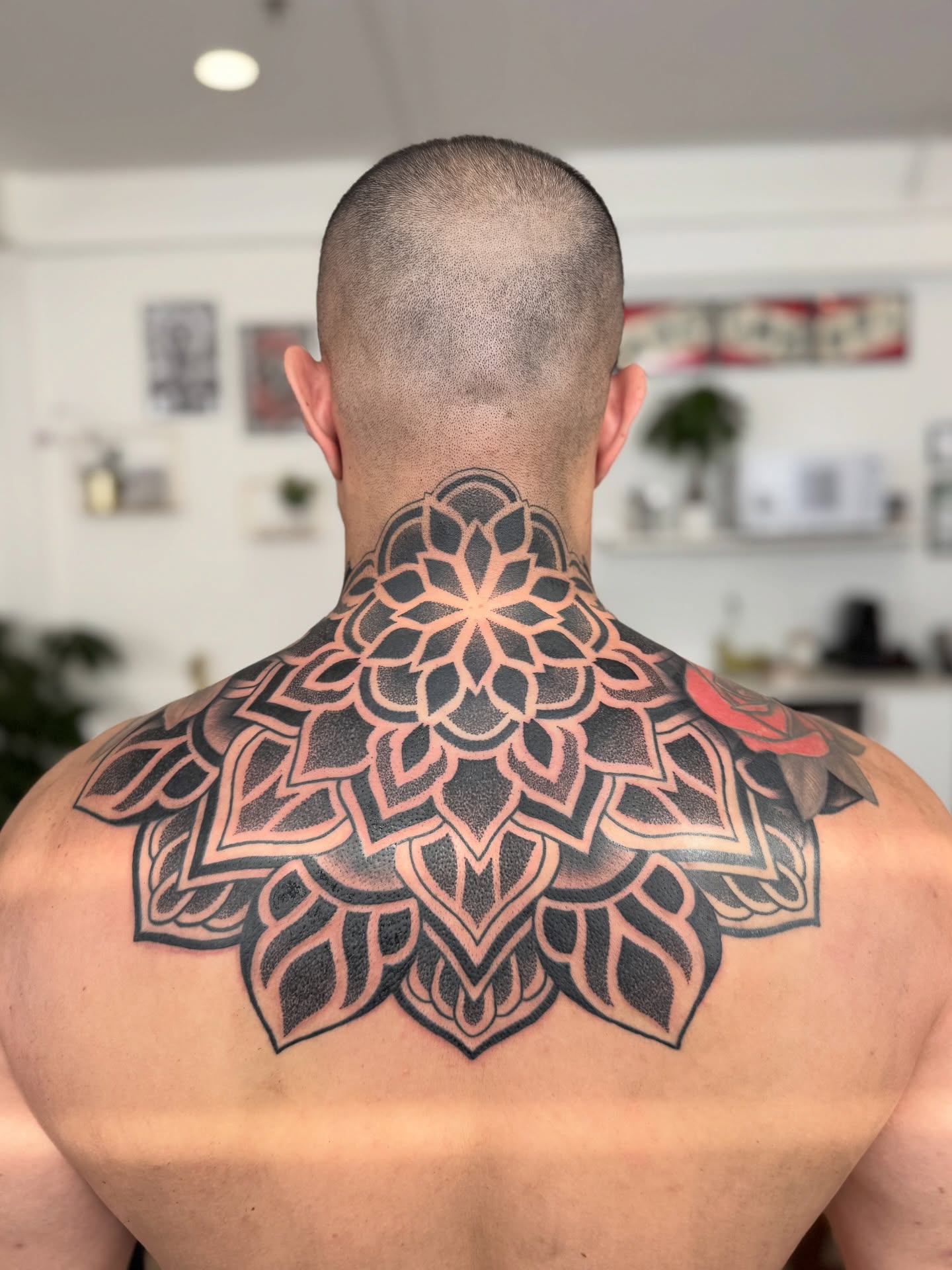 Mandala geometric tattoo on the back by Laure Conzales