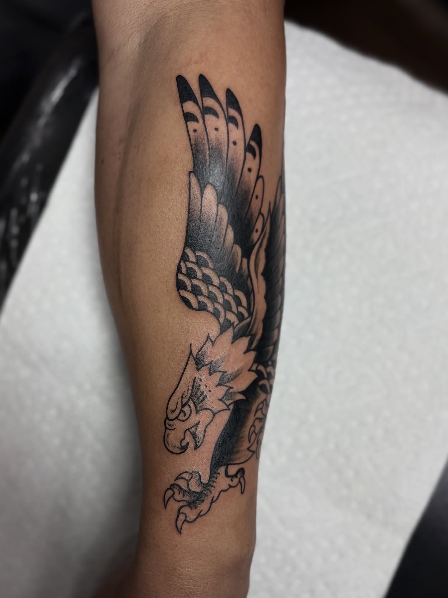 Eagle American traditional tattoo on the forearm by Messias Tattoo Artist