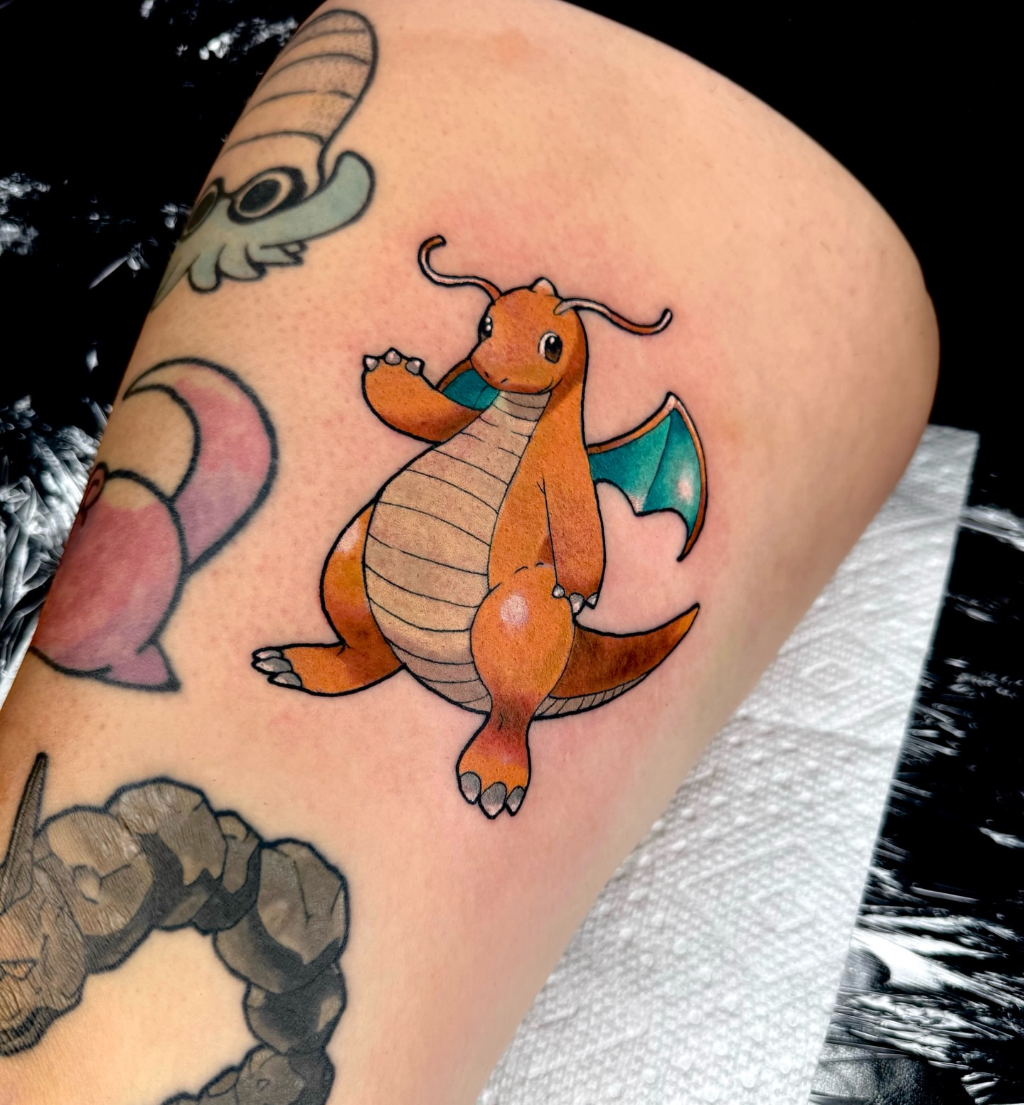 Dragonite new school tattoo on the thigh by Brett Brown