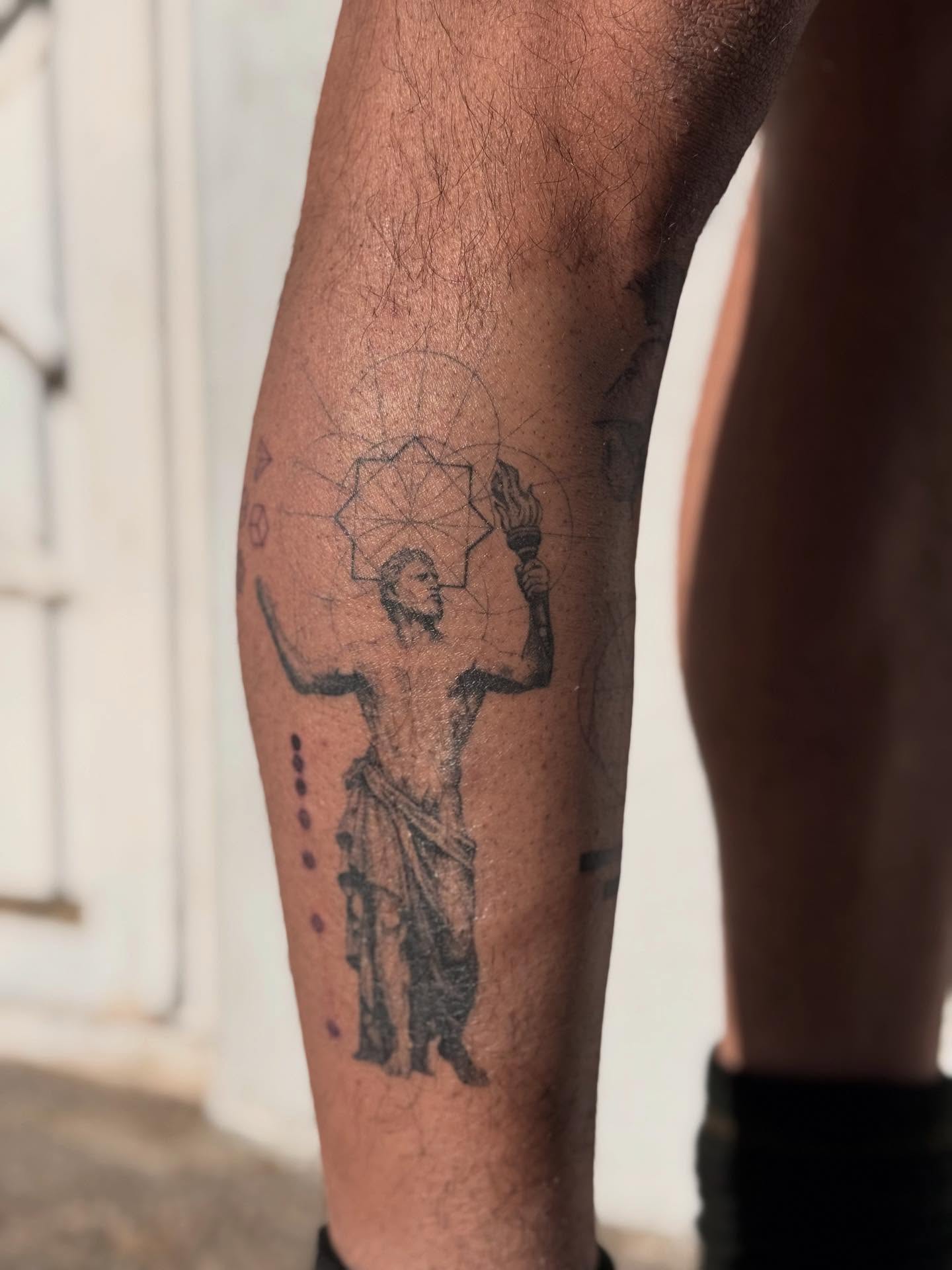 Statue with geometric design geometric tattoo on the calf by Karina ⋆⭒˚.⋆