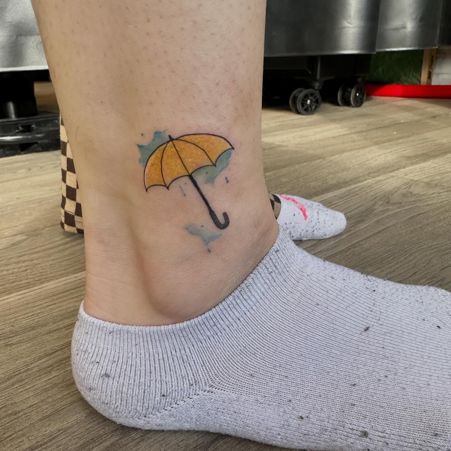 Umbrella watercolor tattoo on the foot by Sam, Mount Laurel, New Jersey