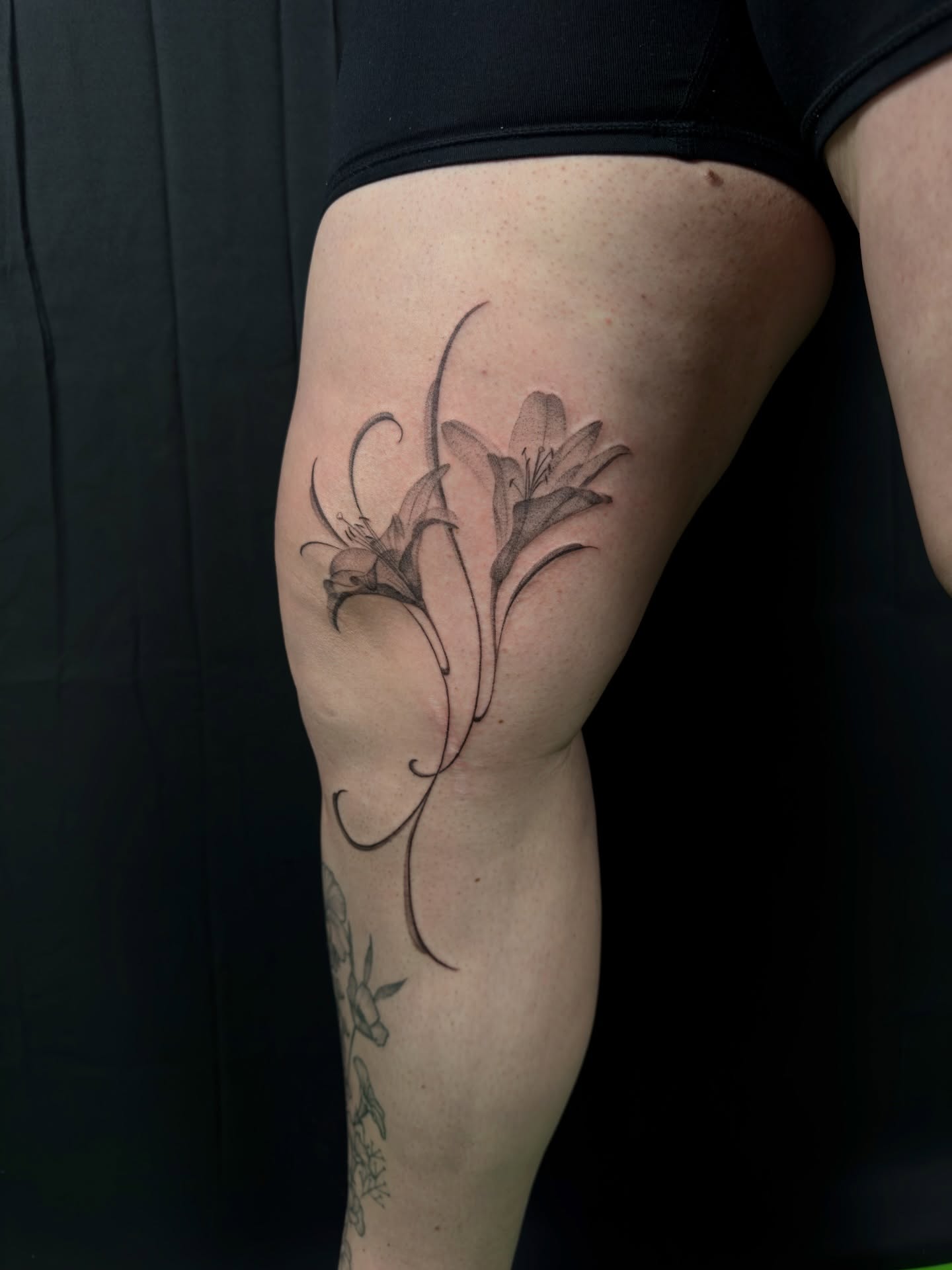 Lily black and grey tattoo on the thigh by Kevin Rotramel, Dayton, Ohio