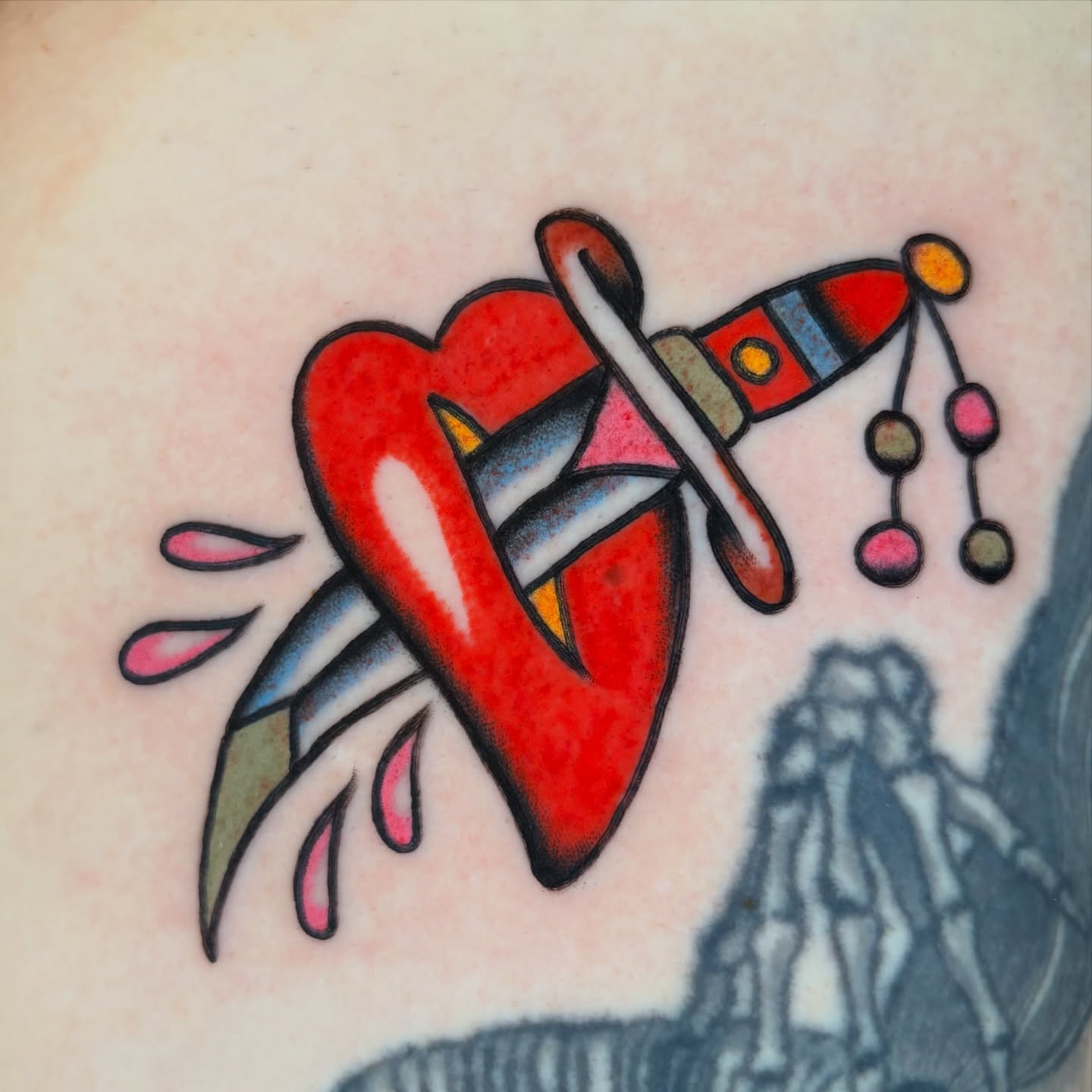 Heart with rocket American traditional tattoo on the torso by rachael