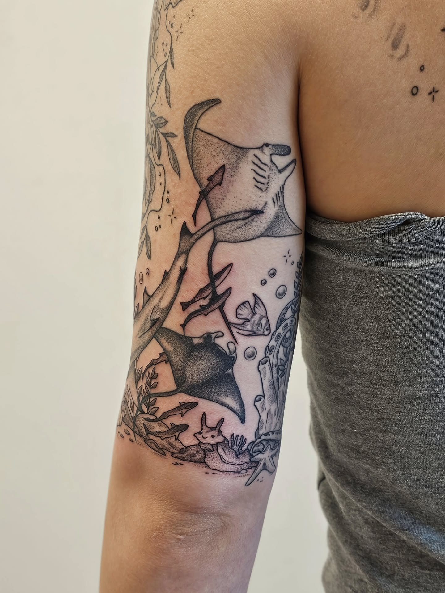 Ray and underwater scene black and grey tattoo on the forearm by Kylie Lund
