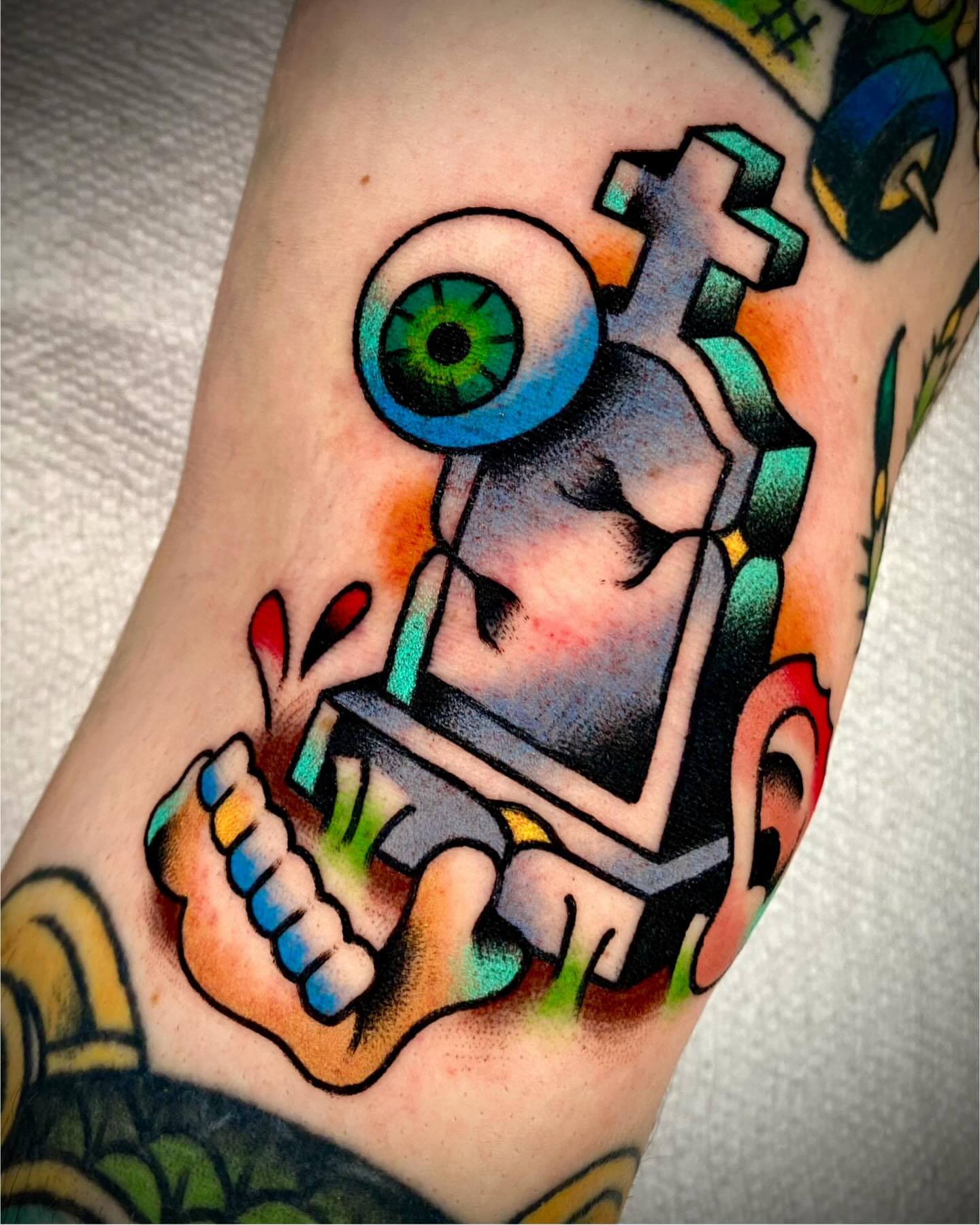 Eye and gear American traditional tattoo on the forearm by Zach Knisley (Wiz)