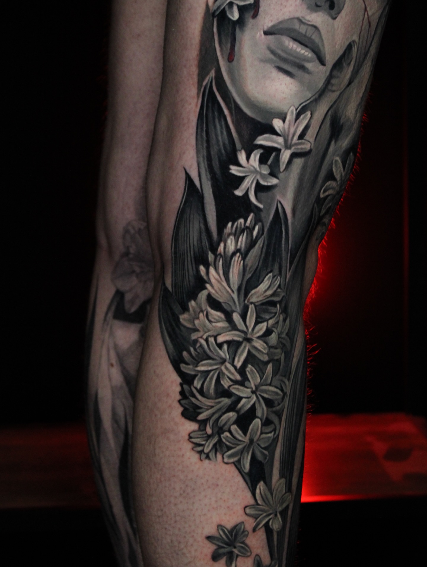 Woman with flowers realism tattoo on the forearm by Eva Williams