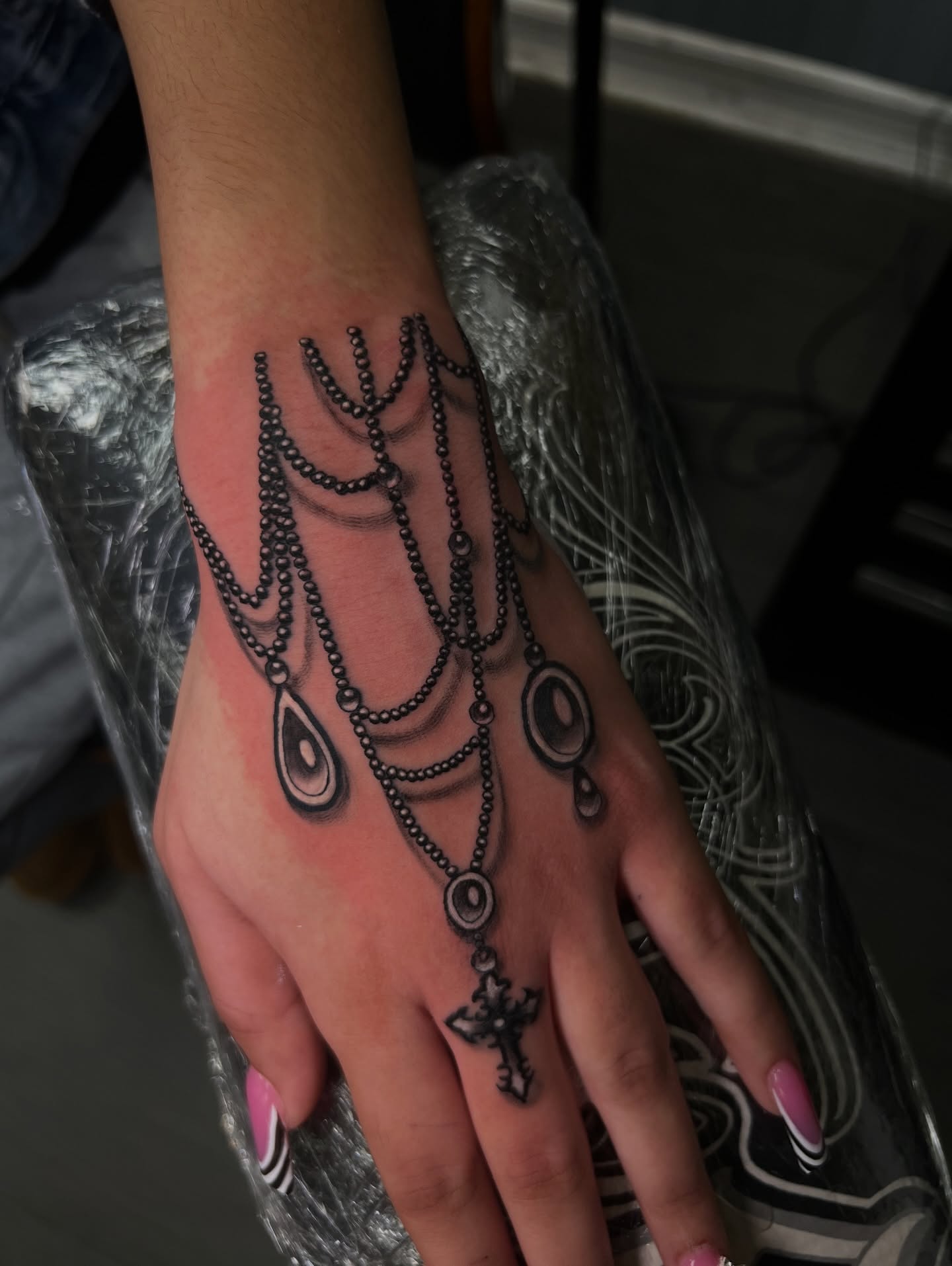 Beaded necklace black and grey tattoo on the hand by Vondrae