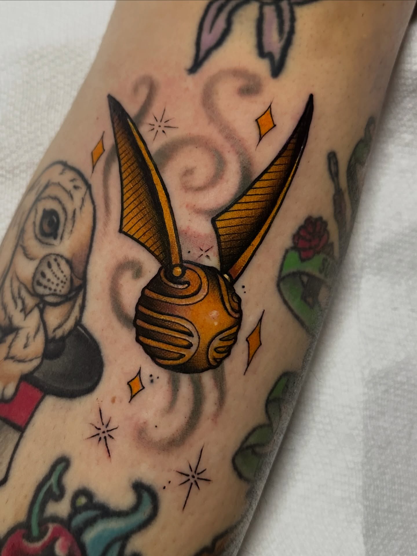 Golden snitch American traditional tattoo on the forearm by K y l e   M a c K e n z i e, Salem, Massachusetts