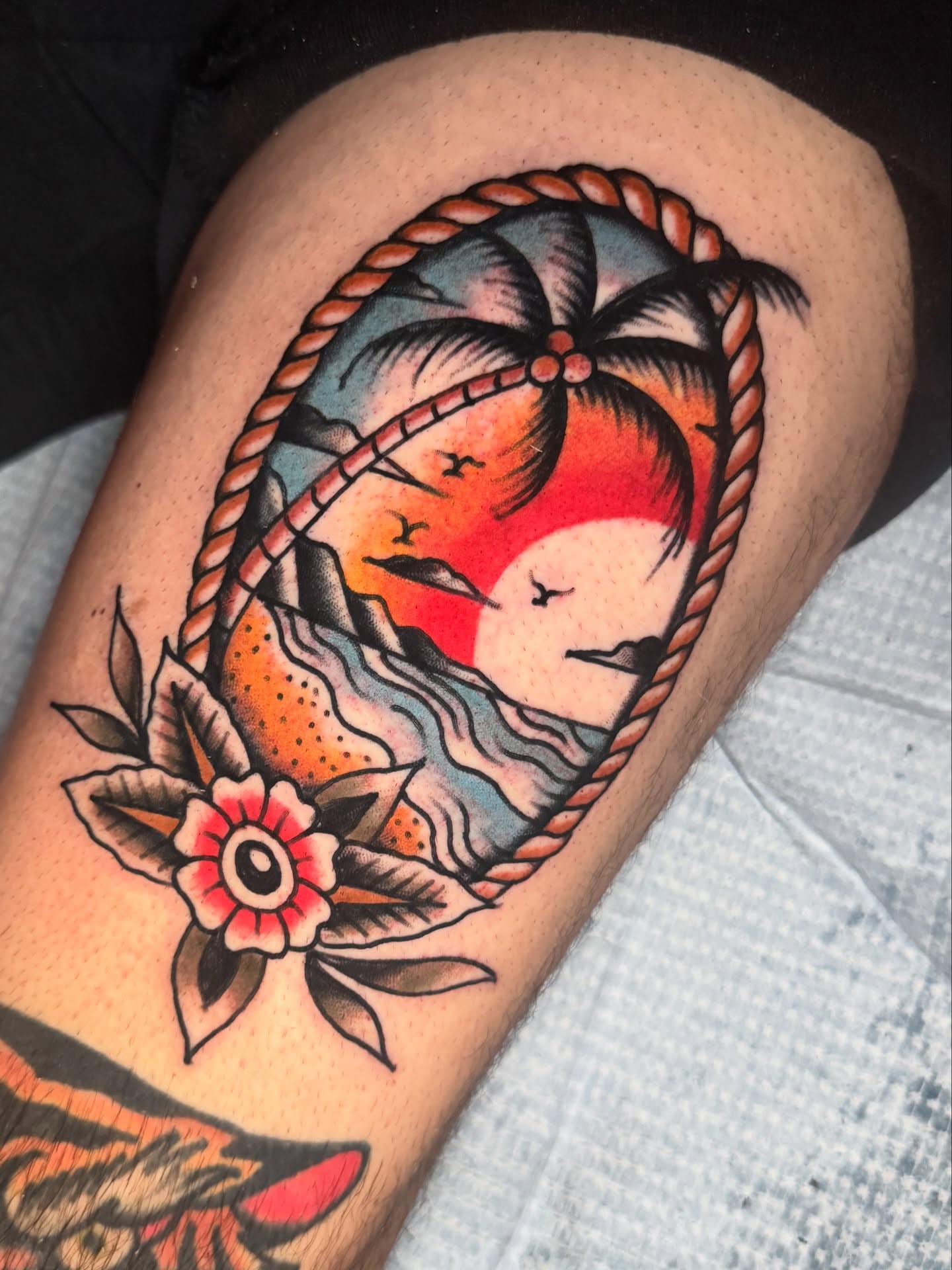 Sunset over ocean American traditional tattoo on the thigh by K y l e   M a c K e n z i e, Salem, Massachusetts