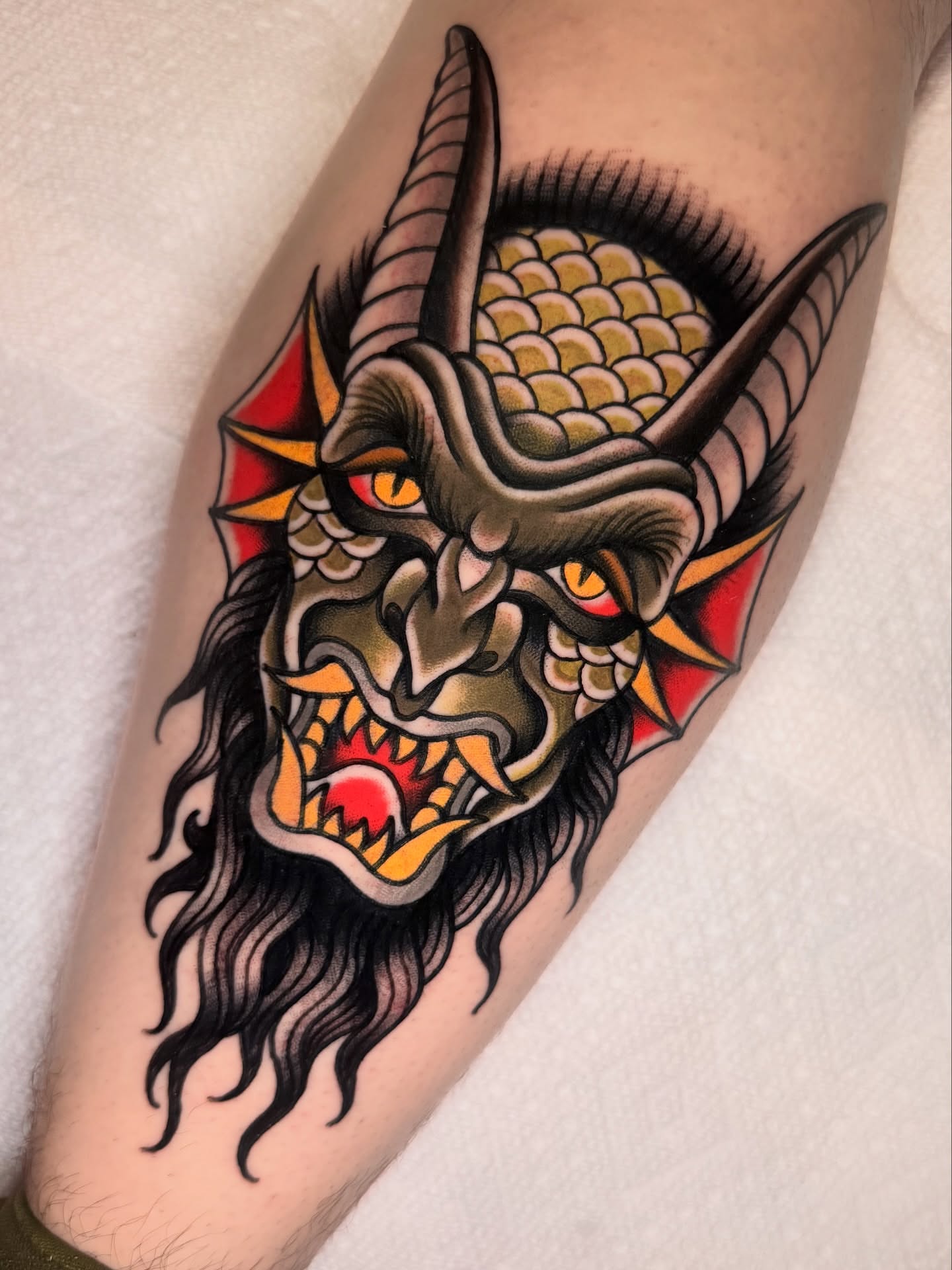 Demon mask American traditional tattoo on the forearm by K y l e   M a c K e n z i e, Salem, Massachusetts