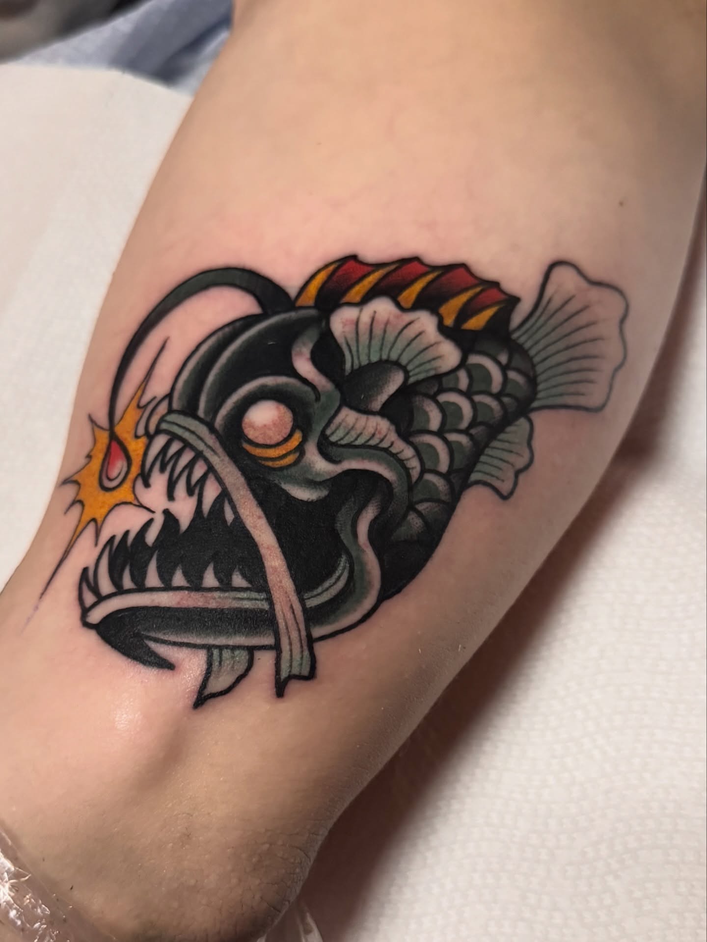 Angler fish American traditional tattoo on the forearm by K y l e   M a c K e n z i e, Salem, Massachusetts