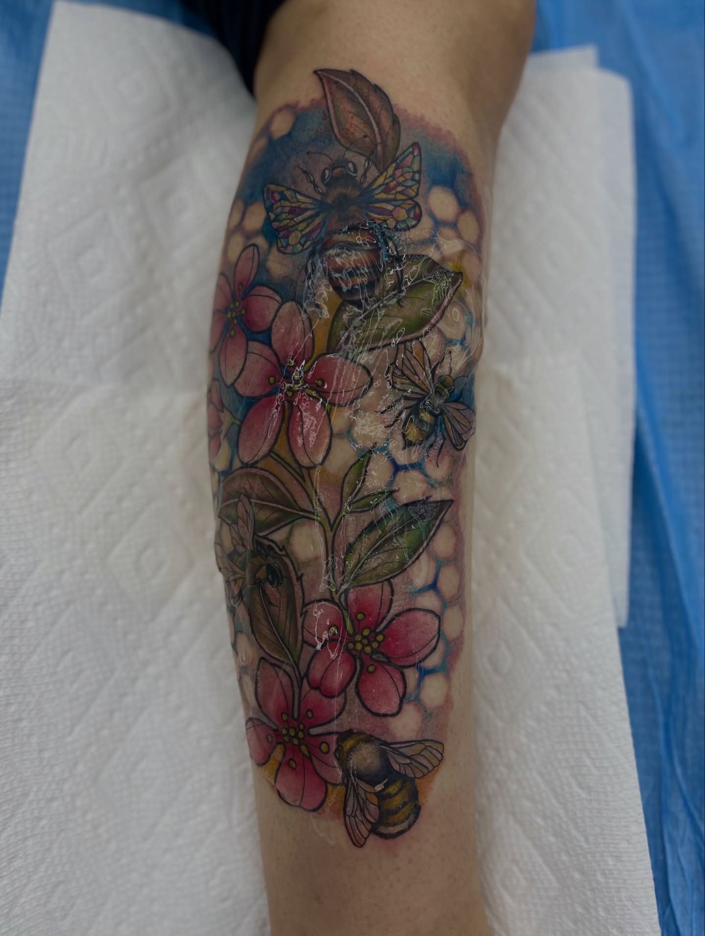 Flowers and bees watercolor tattoo on the forearm by Georgianna Ink, Las Vegas, Nevada