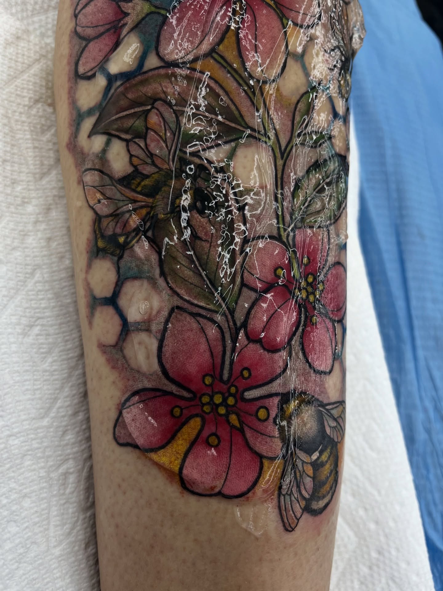 Cherry blossoms and bee watercolor tattoo on the forearm by Georgianna Ink, Las Vegas, Nevada