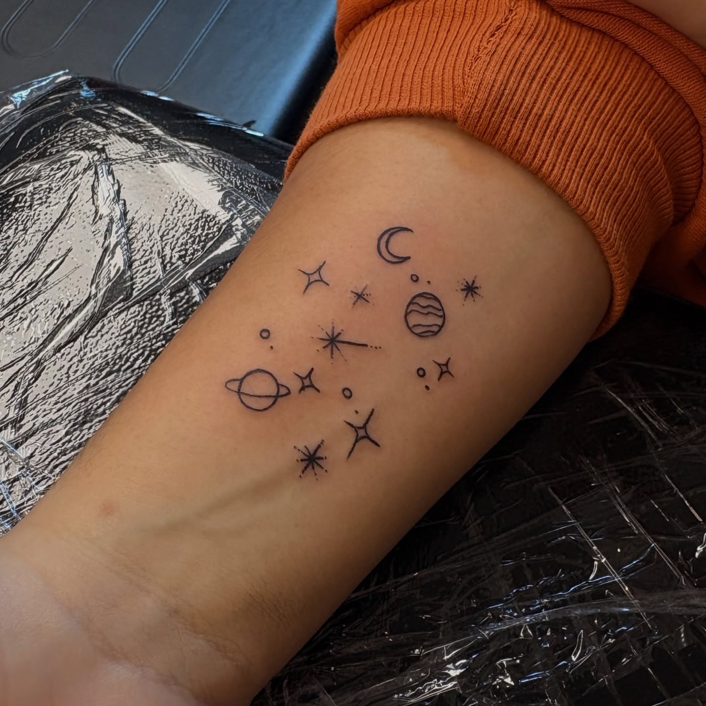 Space-themed symbols minimalist tattoo on the forearm by Emma🌸✨Austin Tattoo Artist