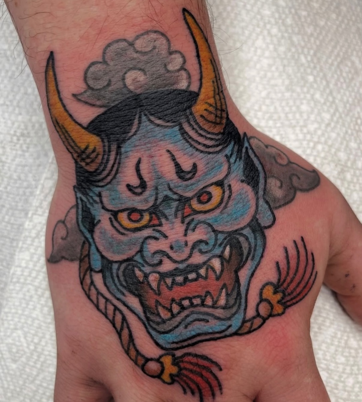 Demon mask American traditional tattoo on the hand by c☮︎urt