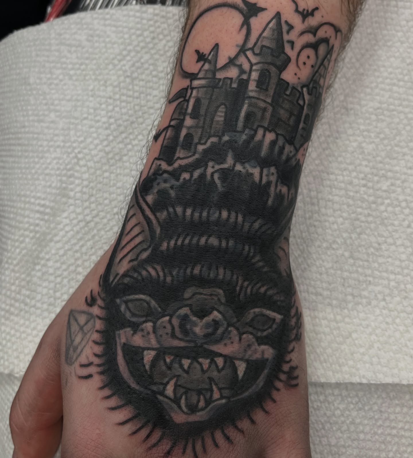 Monster with castle dark realism tattoo on the hand by c☮︎urt