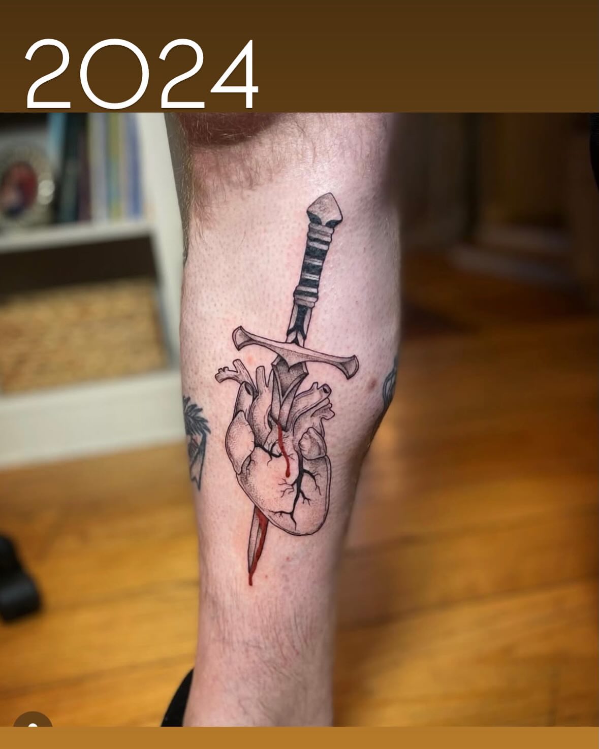 Heart with dagger black and grey tattoo on the calf by Tattoos by Alex