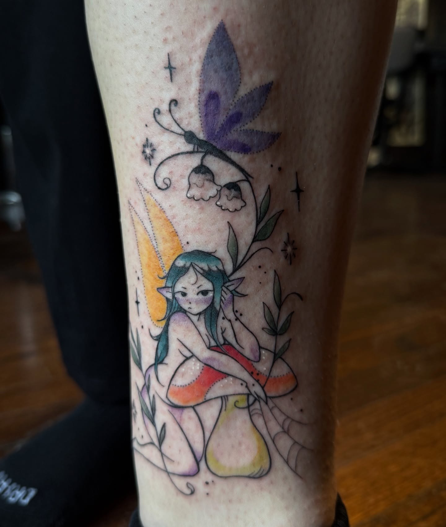 Fairy on mushroom watercolor tattoo on the forearm by Jynx