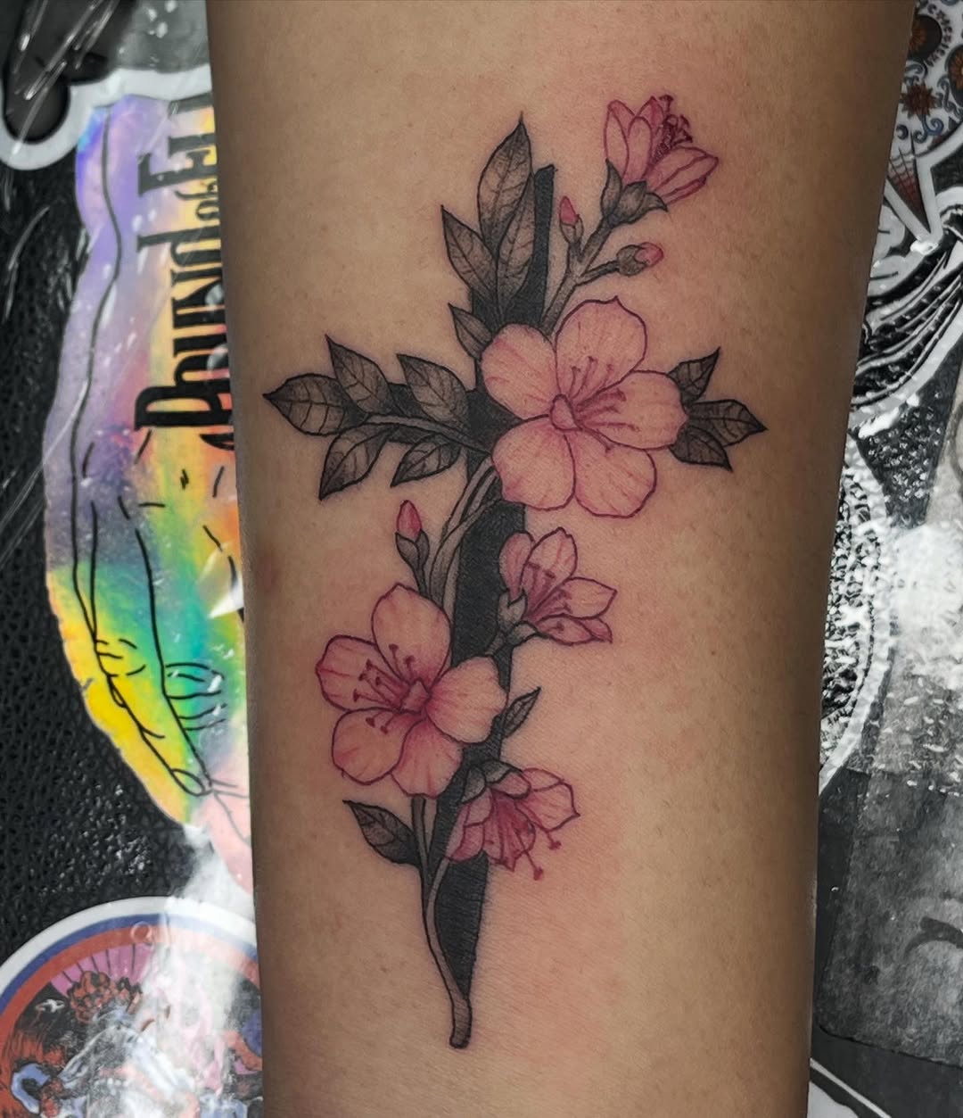 Cross with flowers fine line tattoo on the forearm by destiny🌞