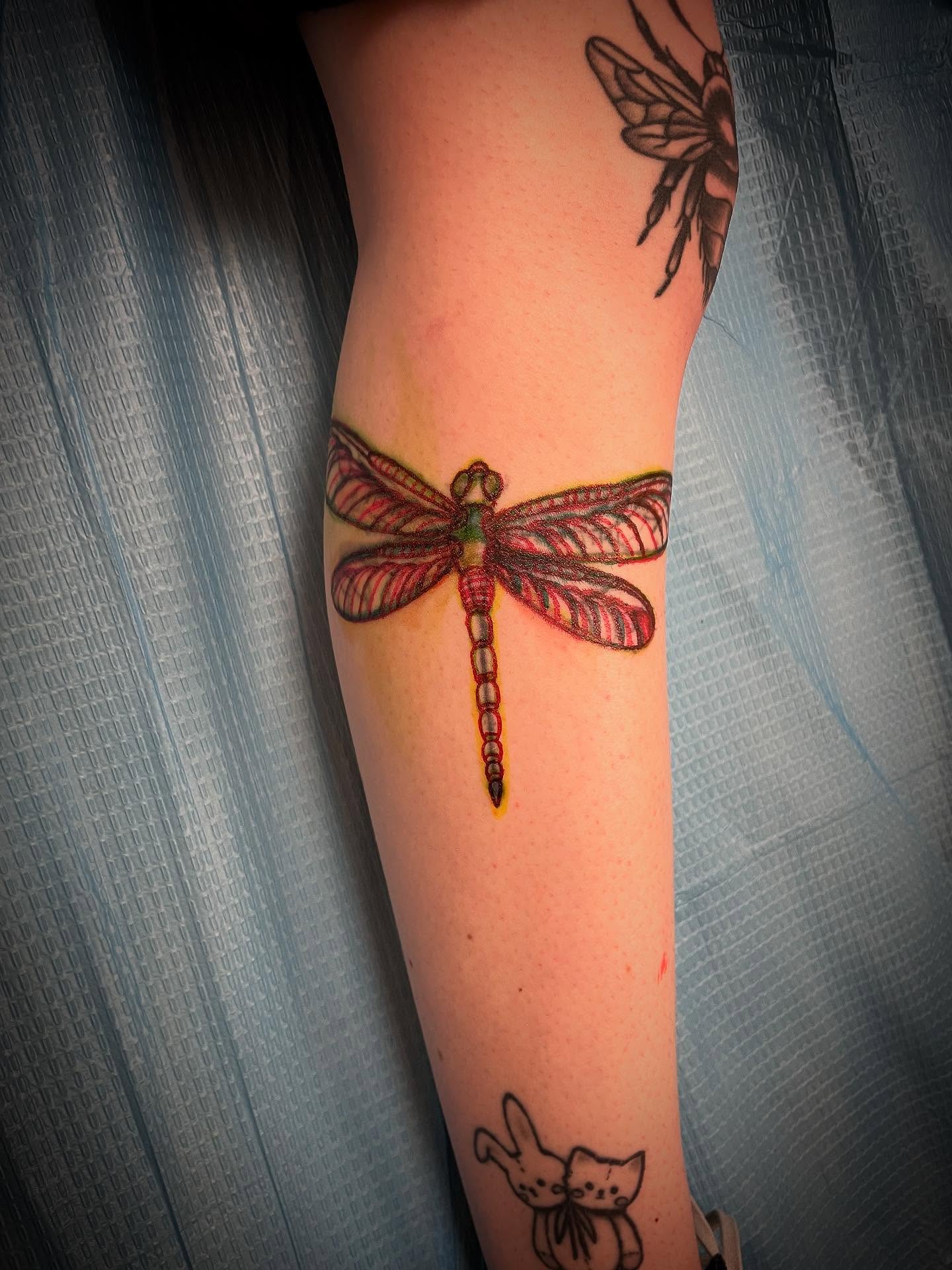 Dragonfly realism tattoo on the forearm by JD Bassett