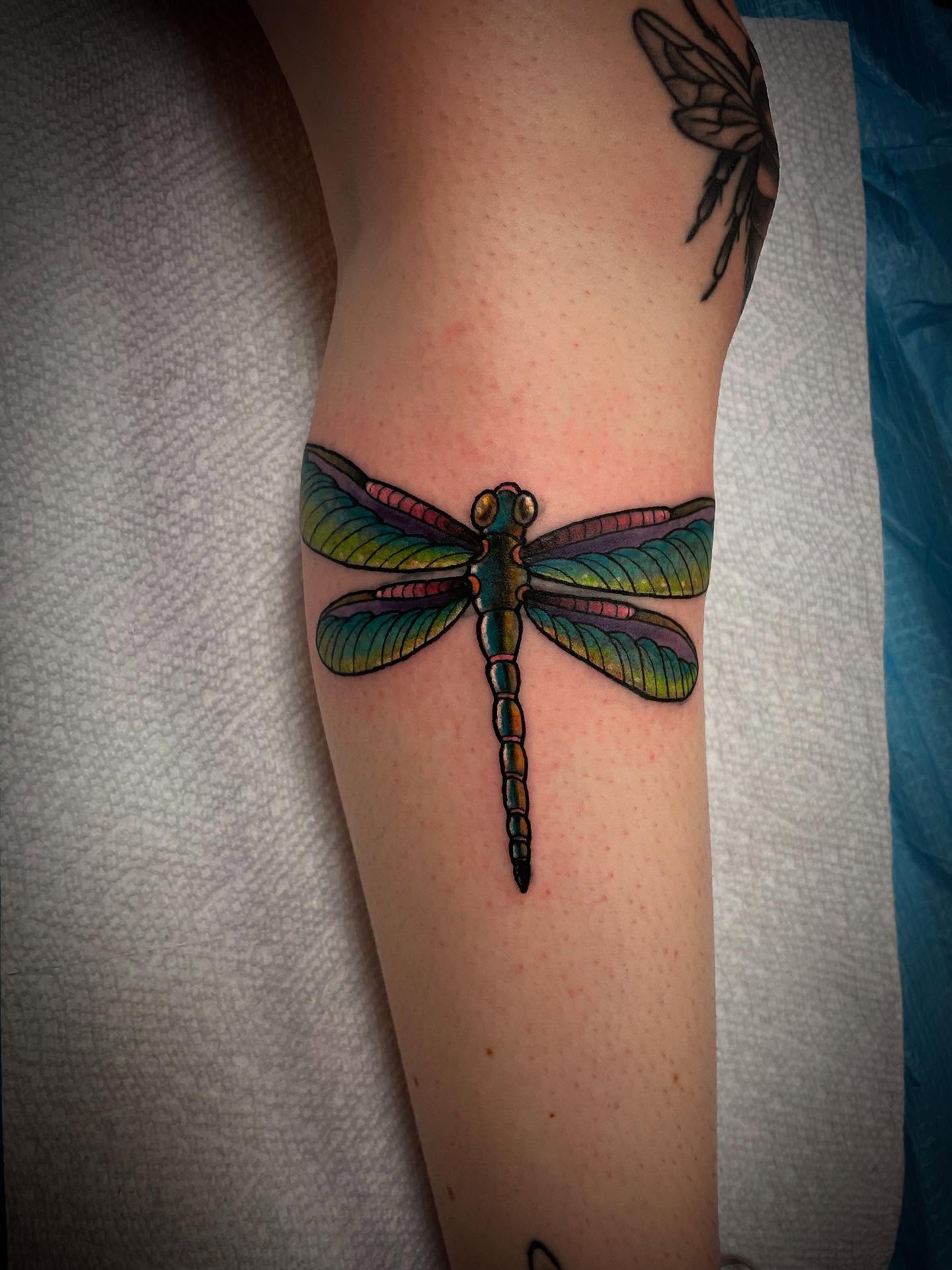 Dragonfly realism tattoo on the forearm by JD Bassett