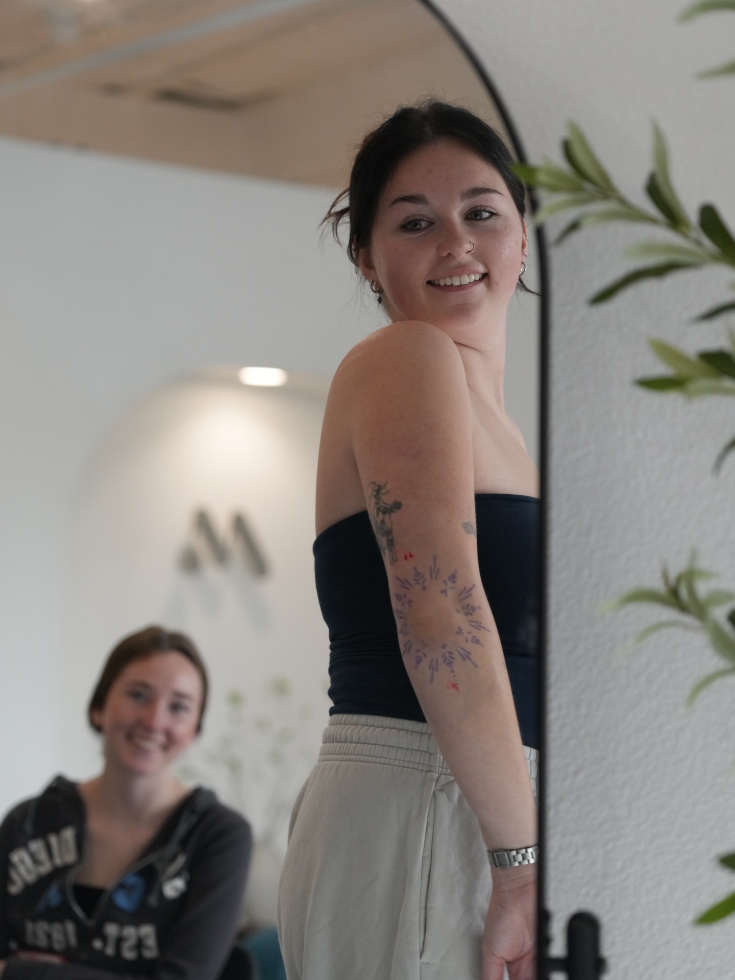 Floral design dotwork tattoo on the upper arm by Lauren