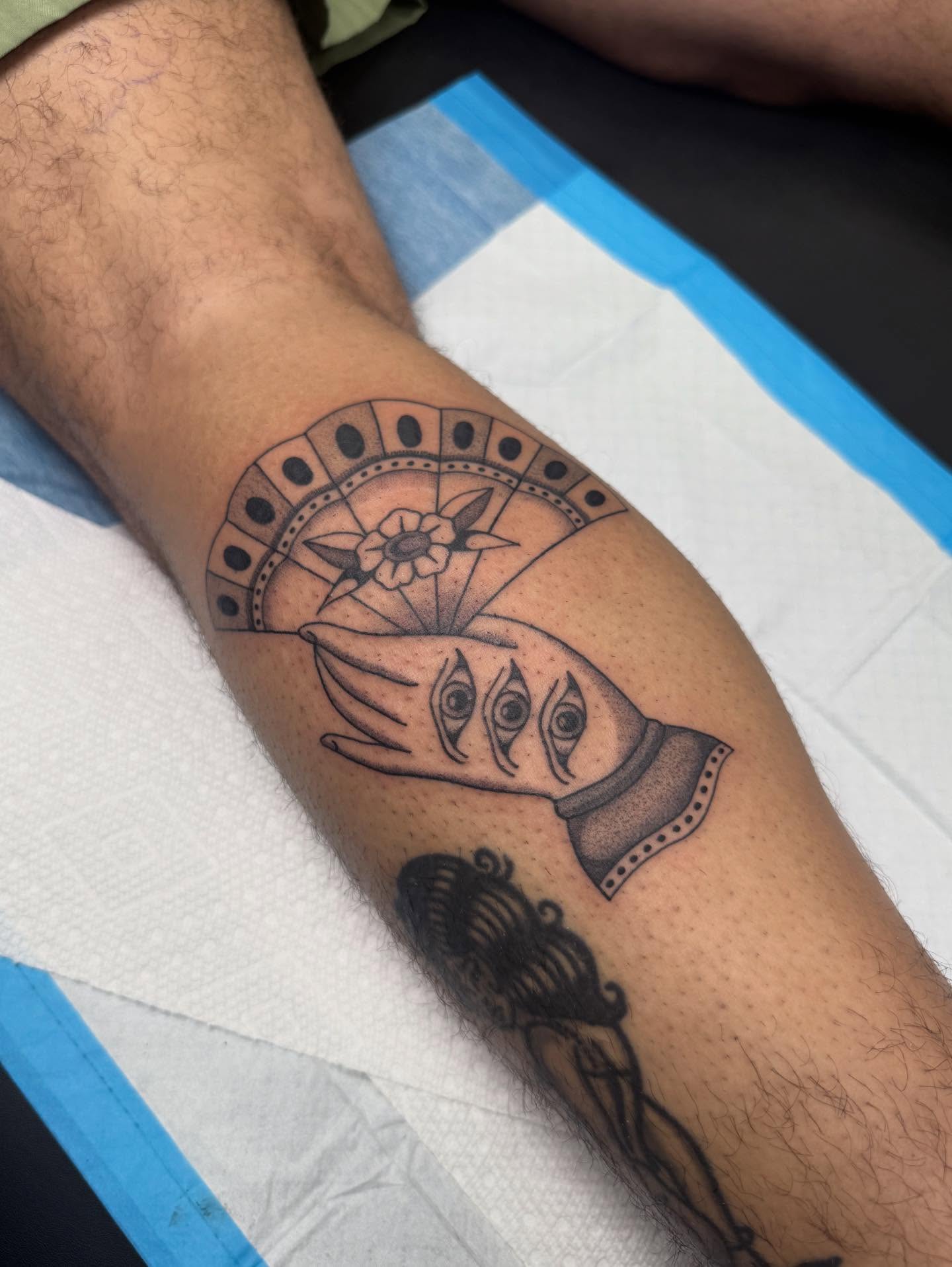 Hands with eyes black and grey tattoo on the forearm by Maddie Jo DeYoung