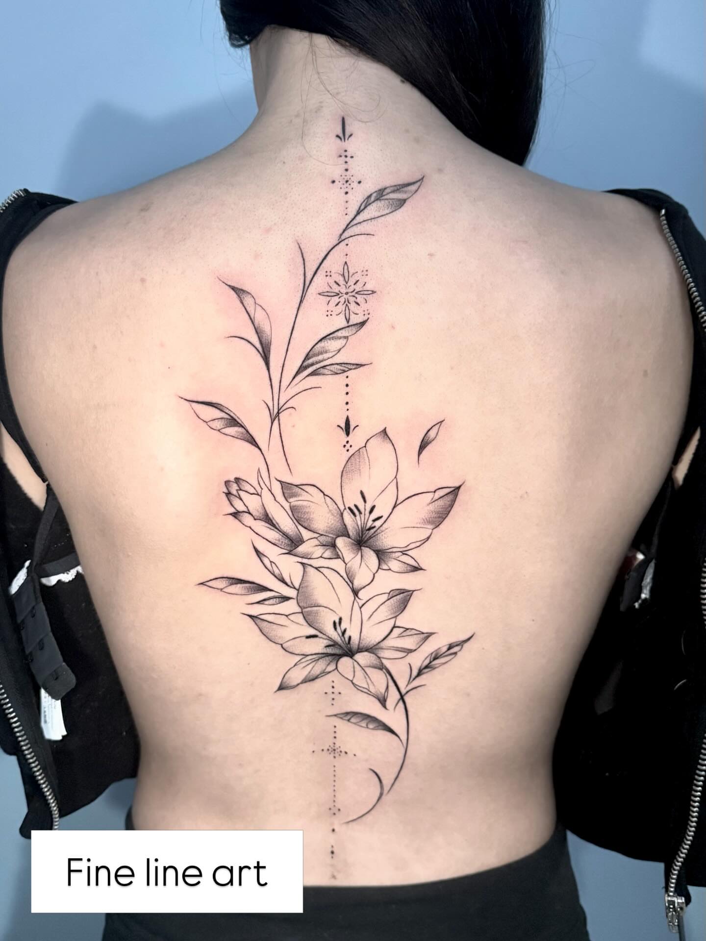 Floral arrangement fine line tattoo on the back by Stilow Memphis Tattoo Artist, Memphis, Tennessee