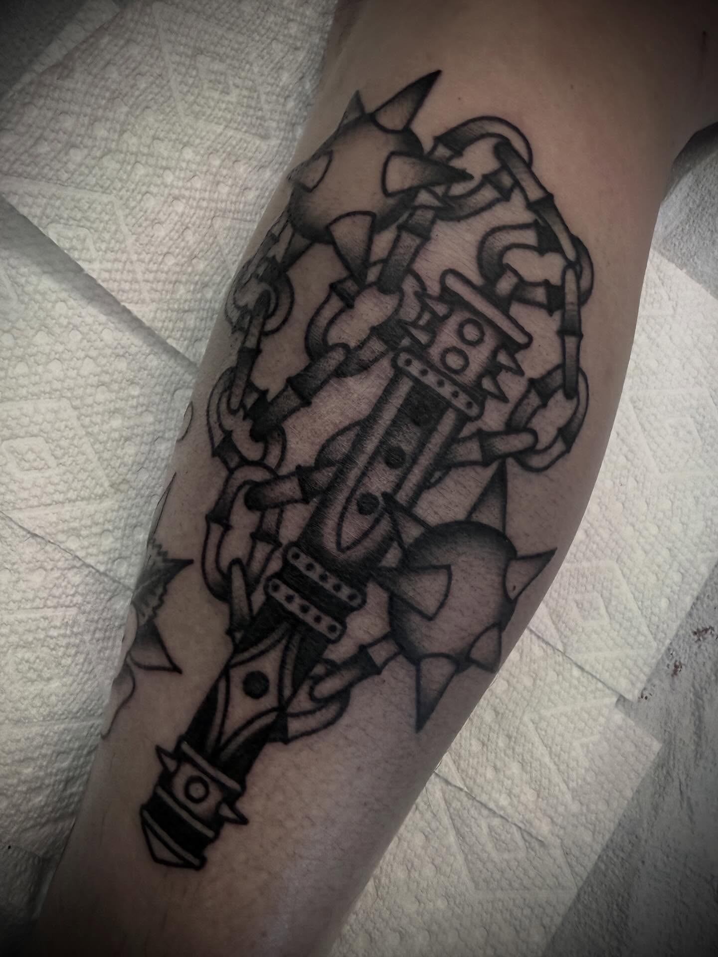 Chains and dagger black and grey tattoo on the forearm by Andrew Slater