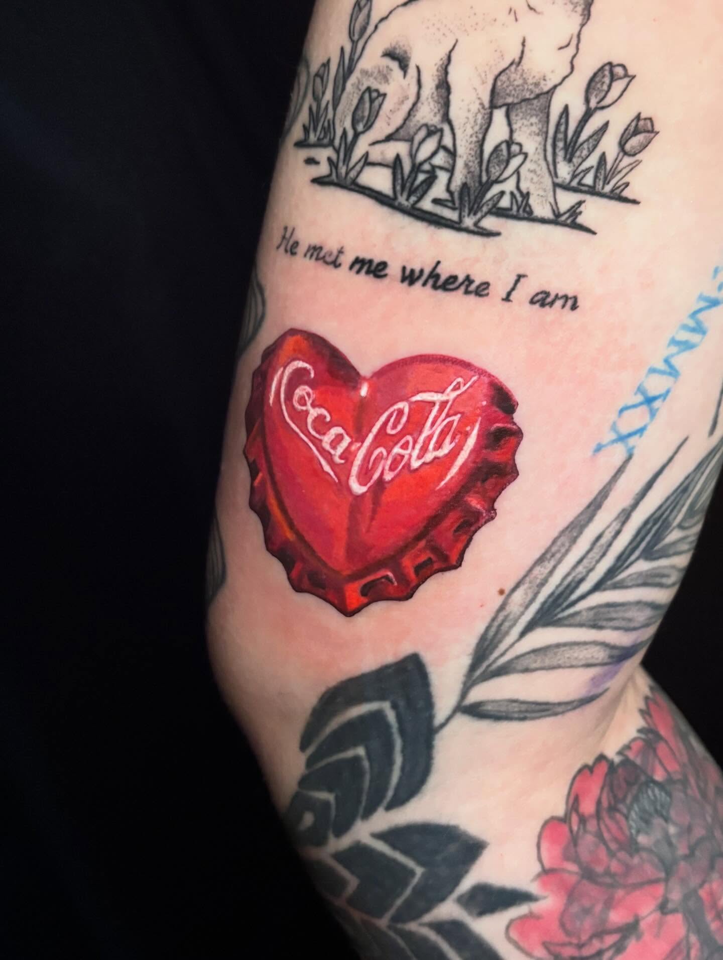 Coca-Cola heart dotwork tattoo on the forearm by Rayvin Patton