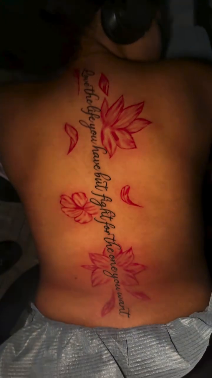 Lotus flowers and script on spine blackwork tattoo on the back by ✨Cole✨, Cleveland Heights, Ohio