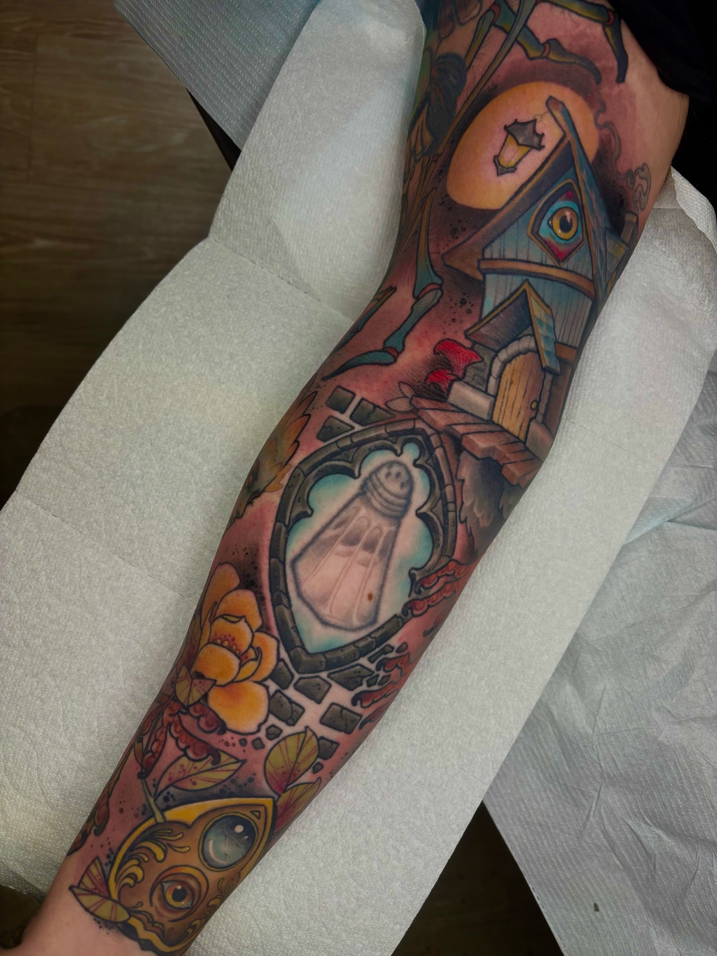 House and clock American traditional tattoo on the forearm by Greg Fischer