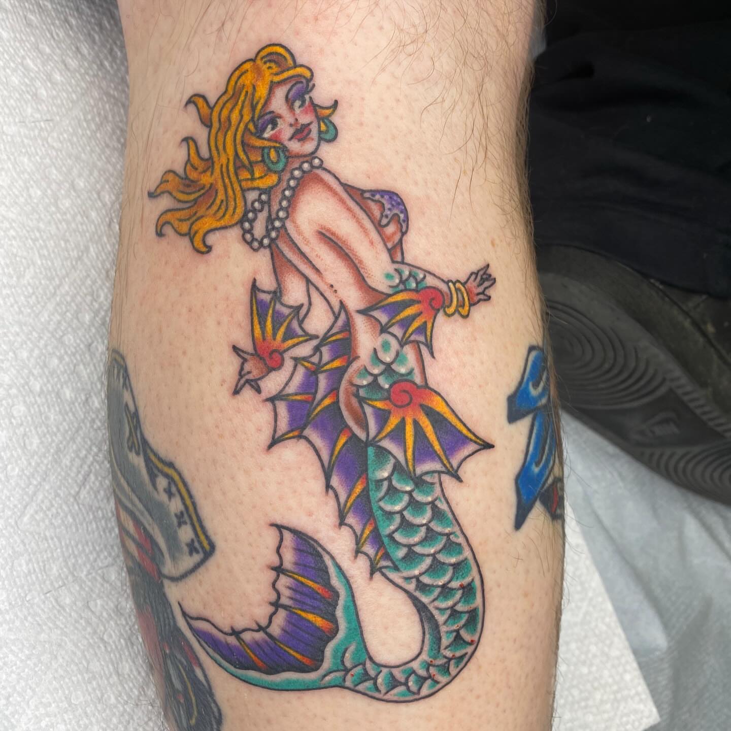 Mermaid American traditional tattoo on the forearm by Thomas Cook