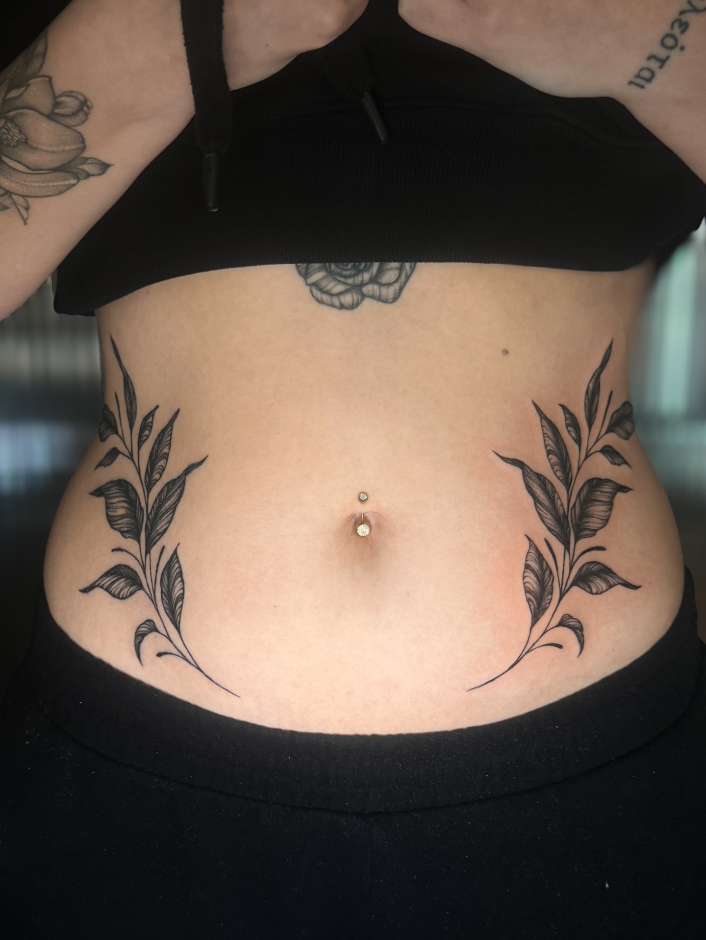 Leaf black and grey tattoo on the torso by Kam Mills