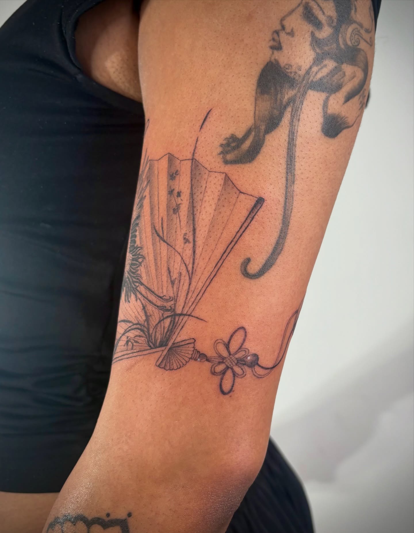Fan and woman black and grey tattoo on the forearm by @tattotos