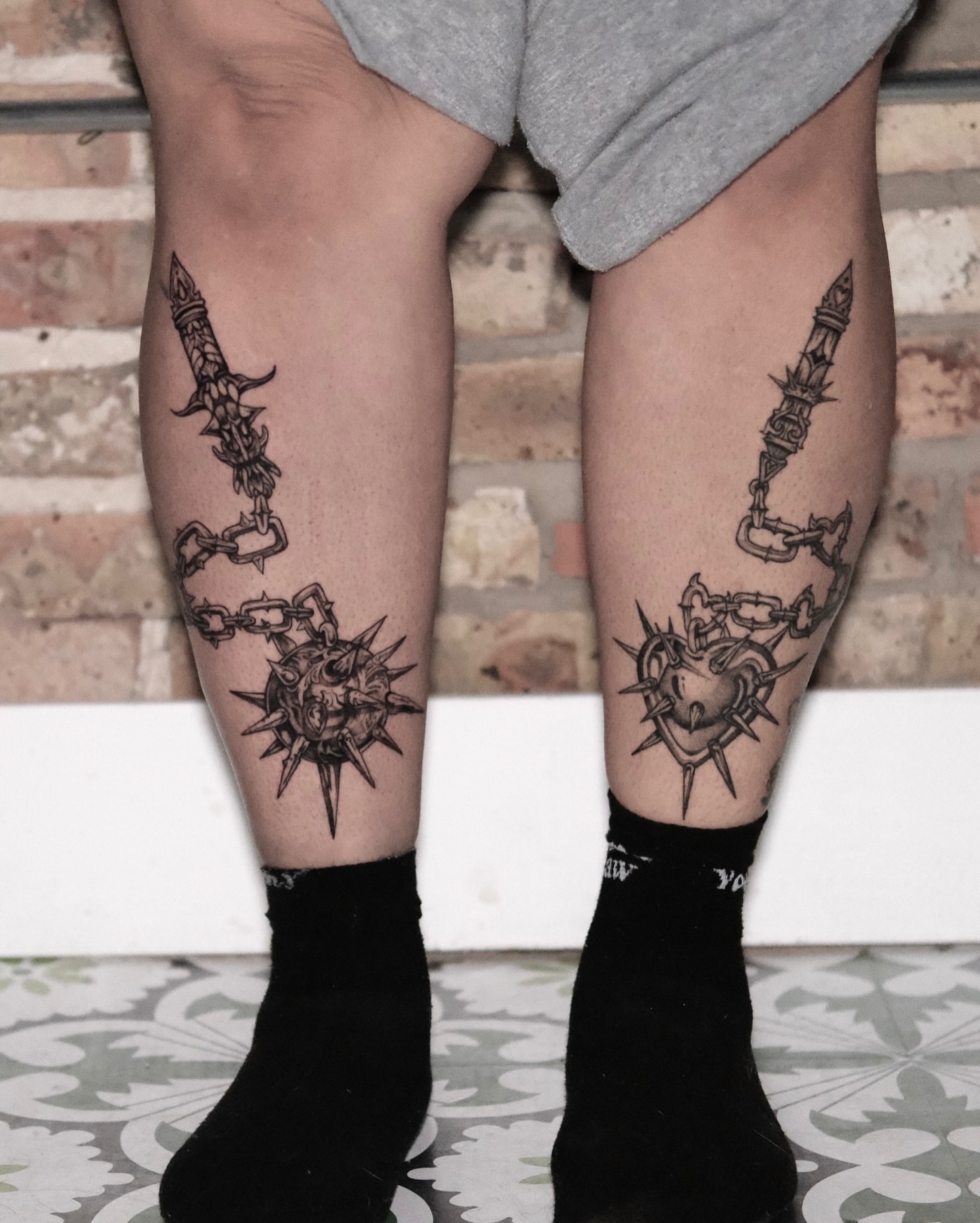 Heart with spikes black and grey tattoo on the leg by Macayla Myers