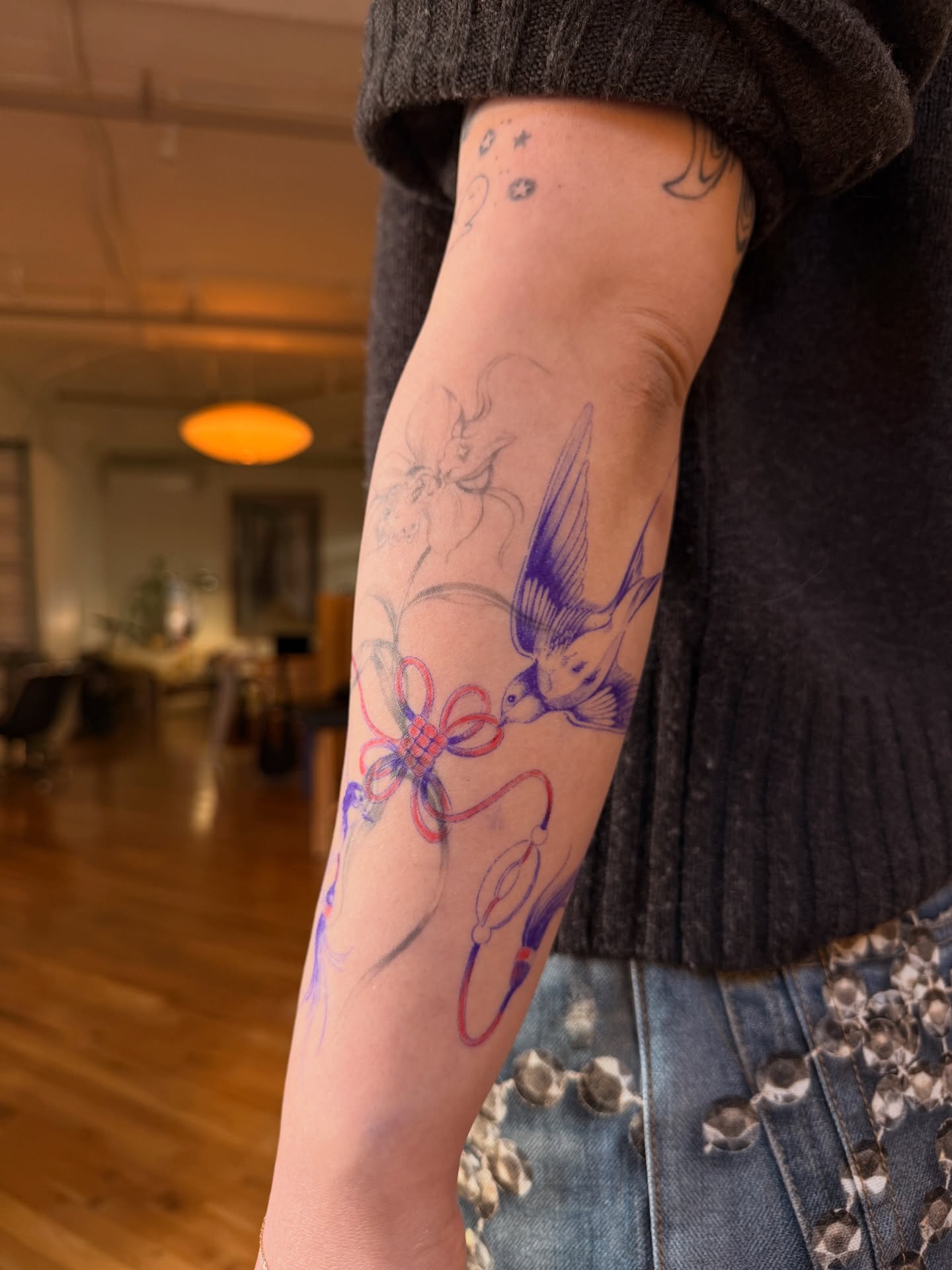 Bird and flower new school tattoo on the forearm by Savana Wang