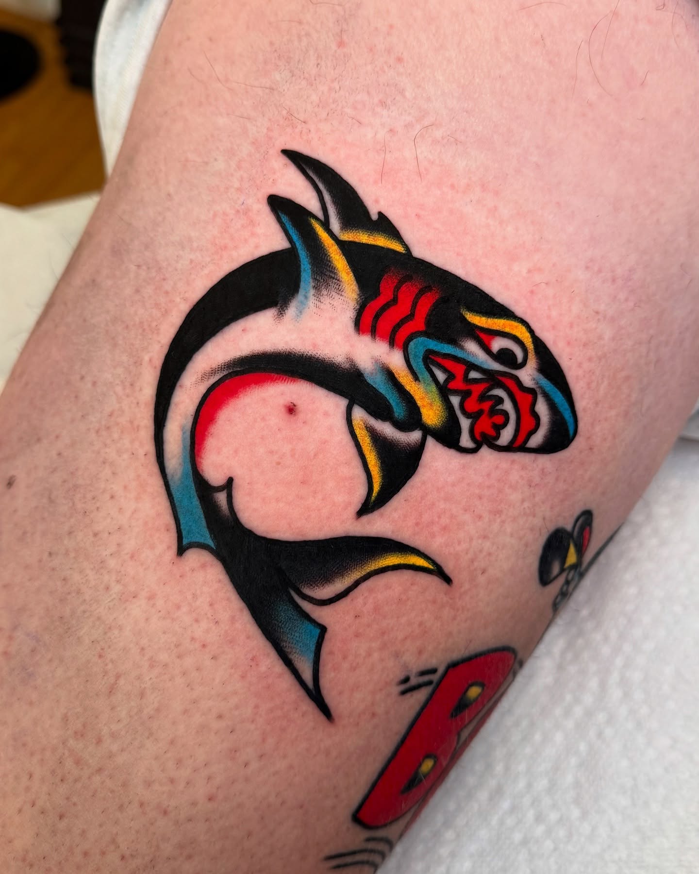 Whale American traditional tattoo on the upper arm by Zachary - Traditional Tattoo Artist