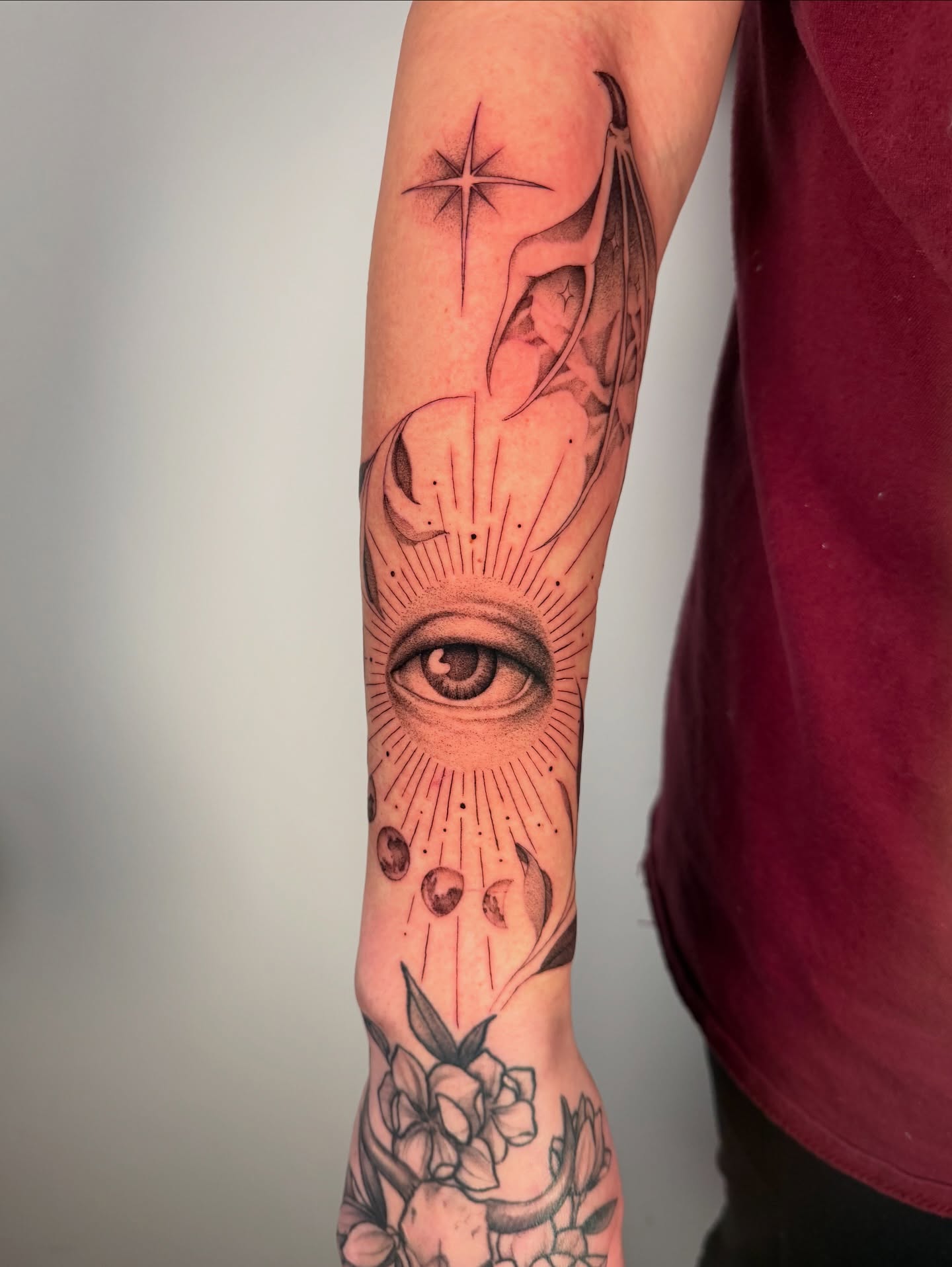 Eye and phases of the moon realism tattoo on the forearm by Cyn